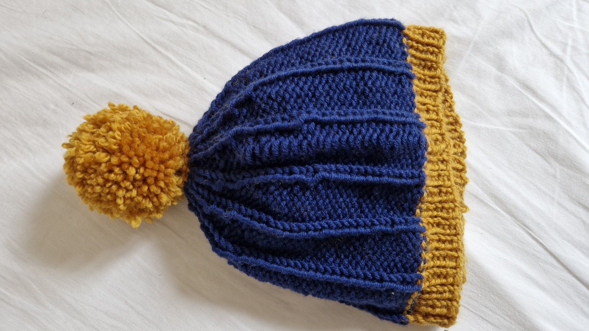 Knitted hat with pompon