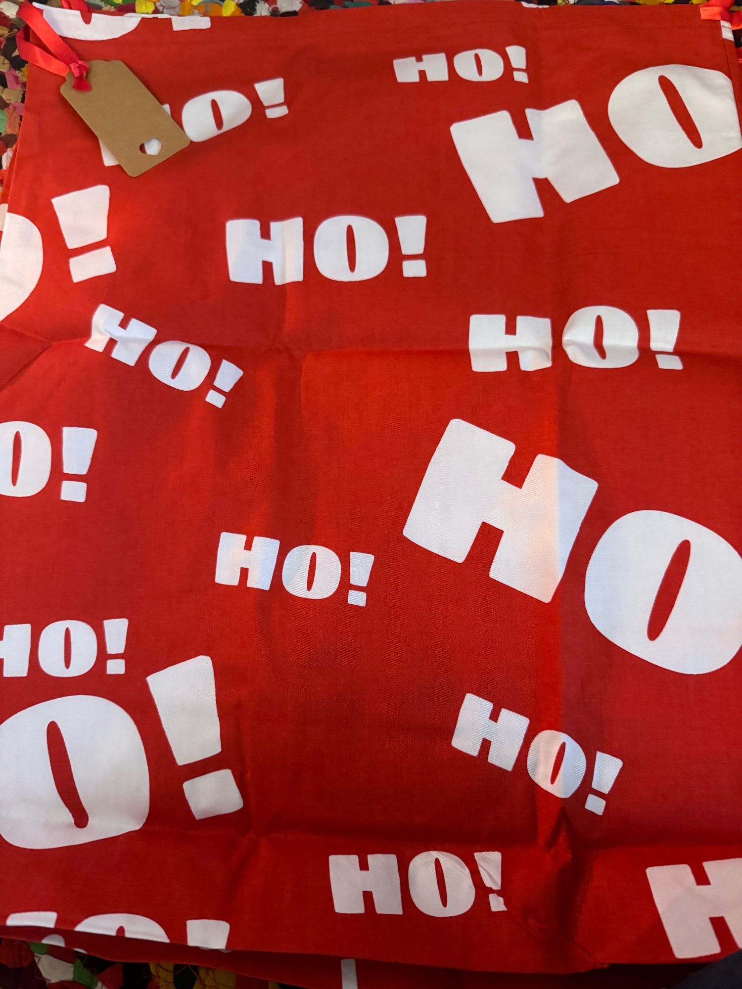 A Christmas bag that says “Ho!” many times. But not “Ho, Ho, Ho!” Just many singular hos.