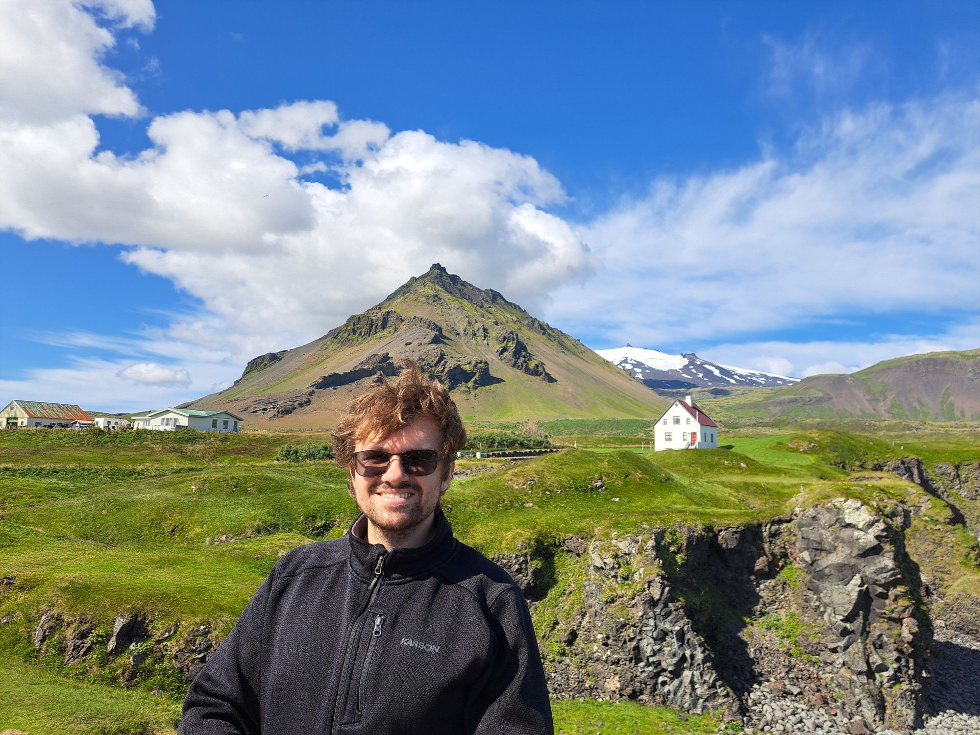 A tiny red cottage on cliff. Mountains and stratovolcano in the background. Another most iconic photo spot in Iceland.