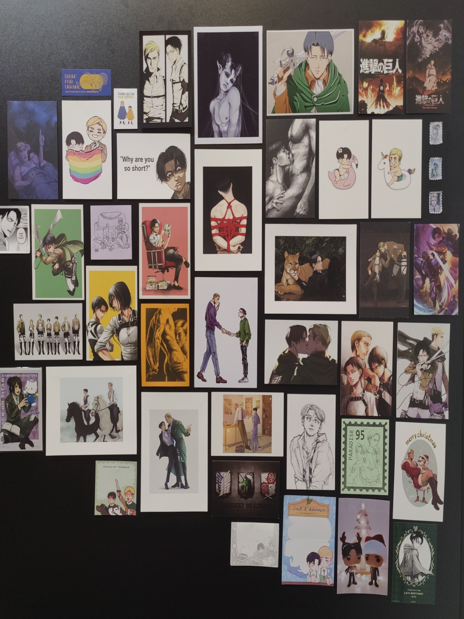 wall full of various art prints and postcards featuring eruri