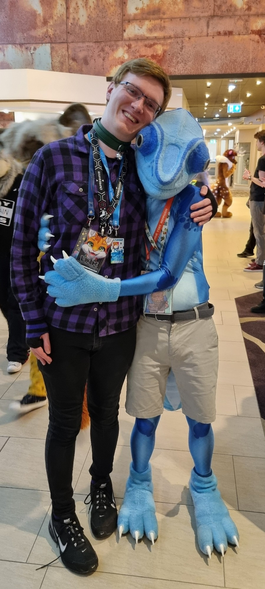 A photo of Link hugging Blue Chameleon in suit