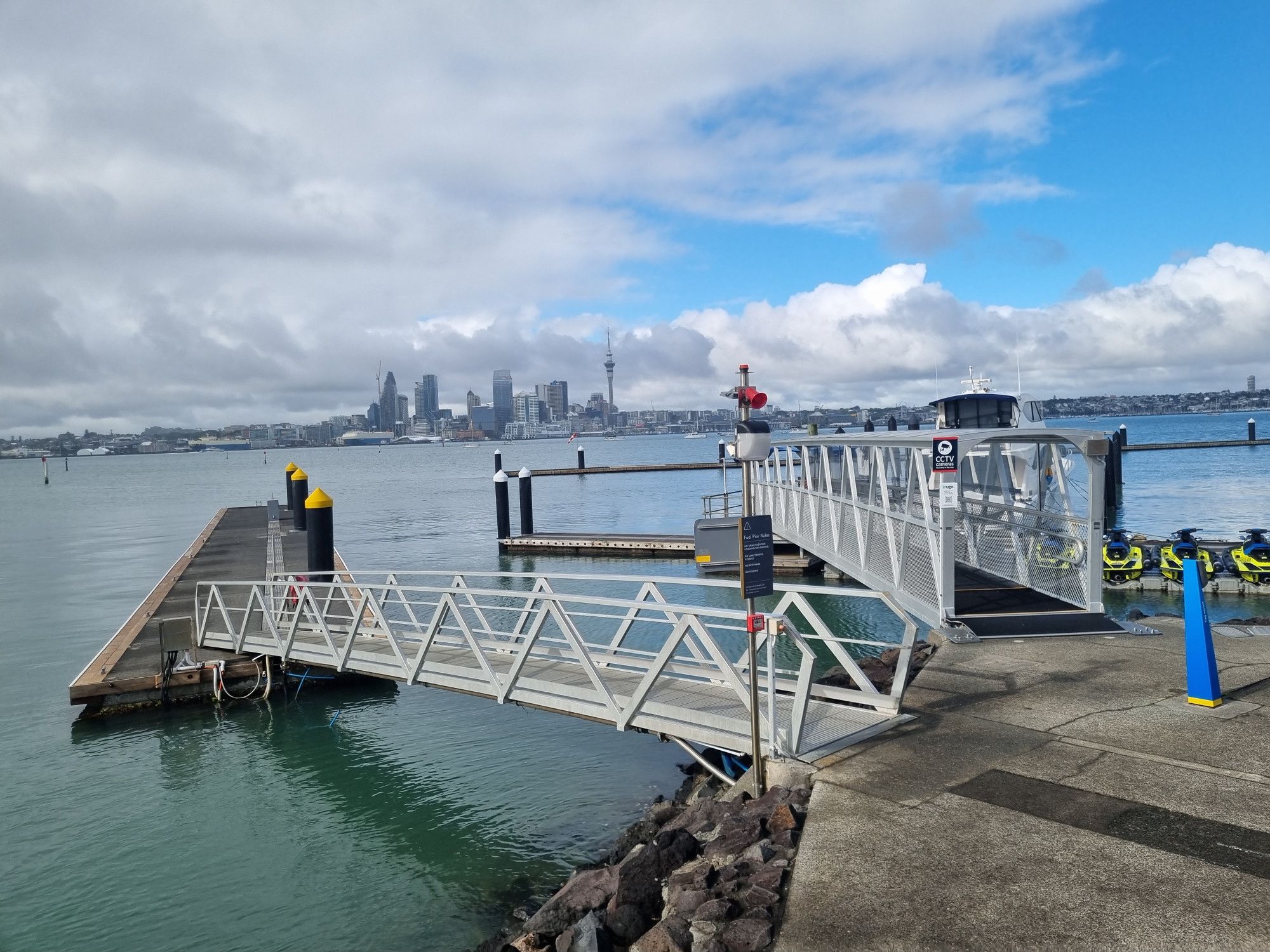 Bayswater ferry terminal with Auckland City Centre visible across the water, and no ferry because it's left already