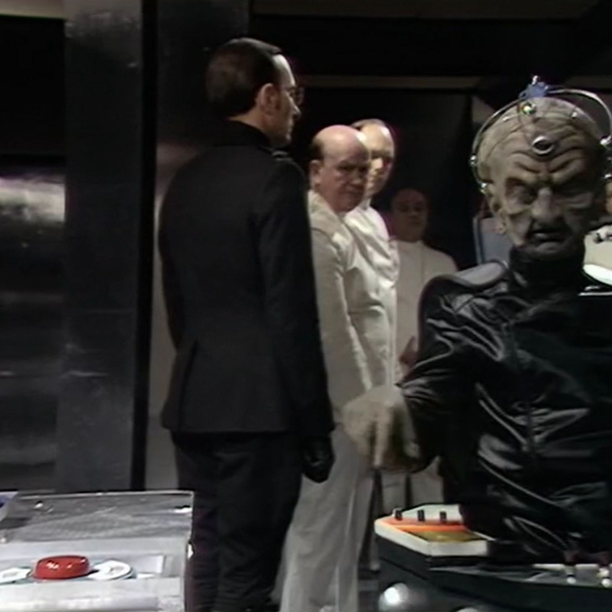 Davros, looking at a big red button with Total Destruct label.