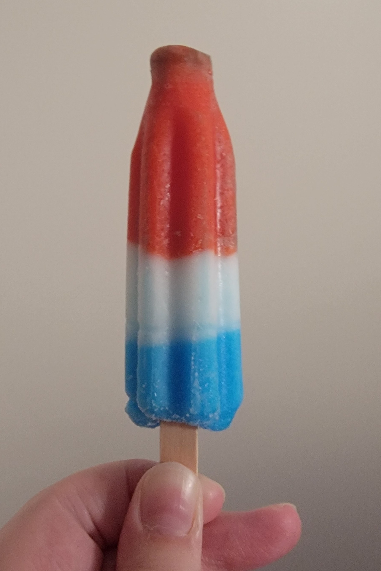 Popsicle that is mostly red, with little white or blue.