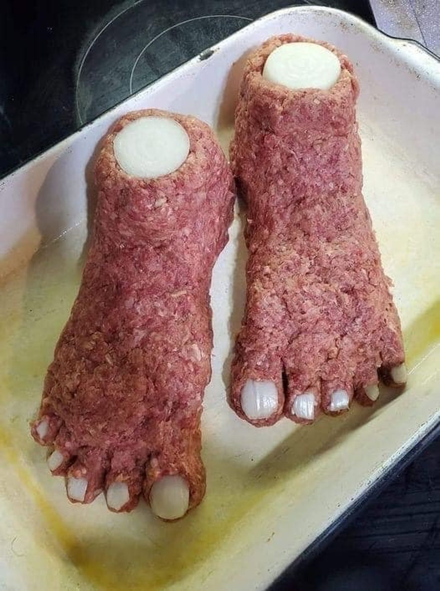 - Amontoados de carne moída em forma de dois pés decepados do corpo;
- Duas rodelas de cebola acima do calcanhar dão a impressão de serem ossos (tíbia);
- Pequenos pedaços de cebola nos dedos dão a impressão de serem unhas;
- A iguaria está disposta em uma assadeira metálica de cor branca.