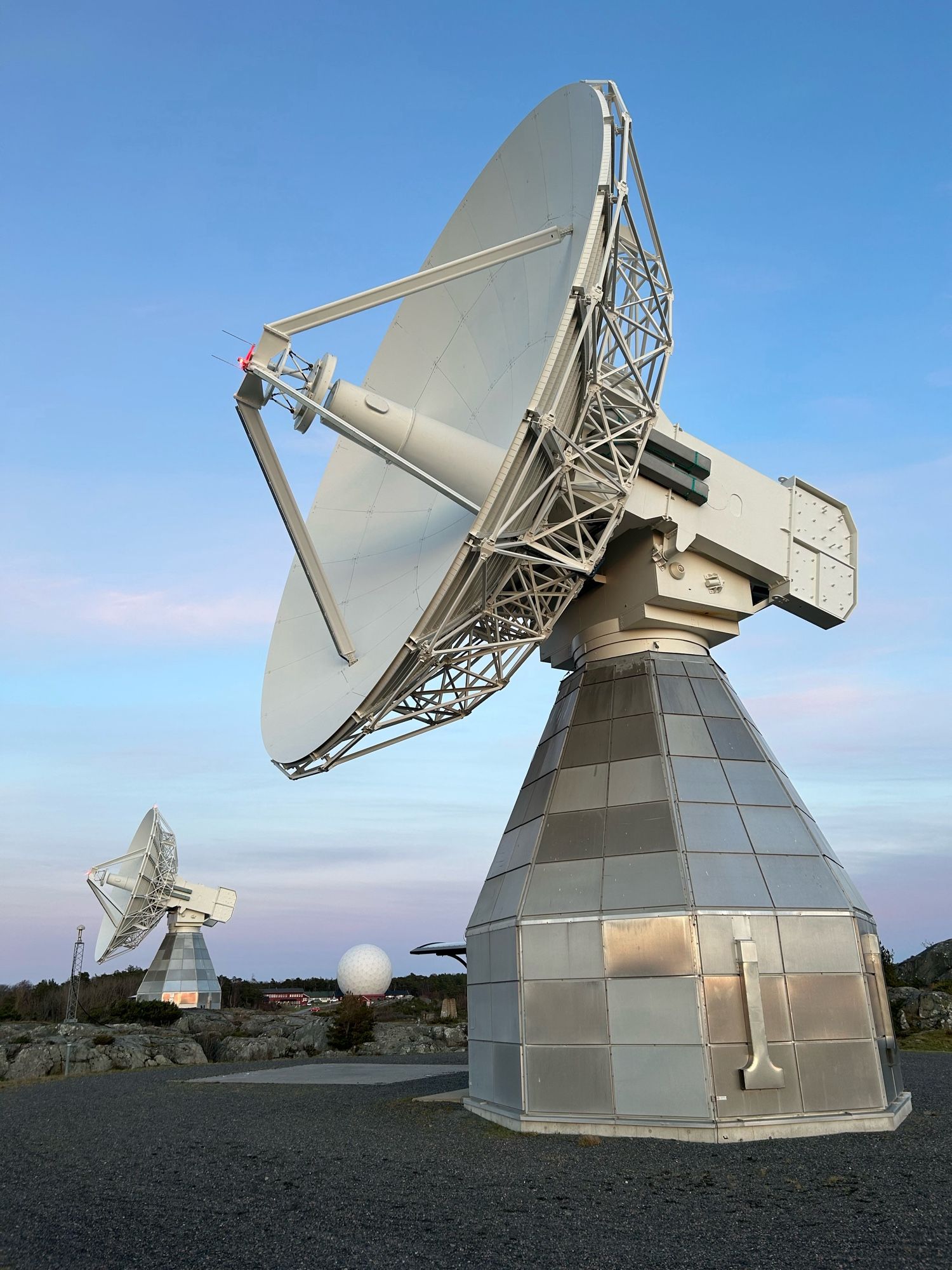 Onsala twin telescopes with the radome of the Onsala 20m between them at a distance. This is looking east away from the sunset, so the light is soft and the thin clouds are lightly pink