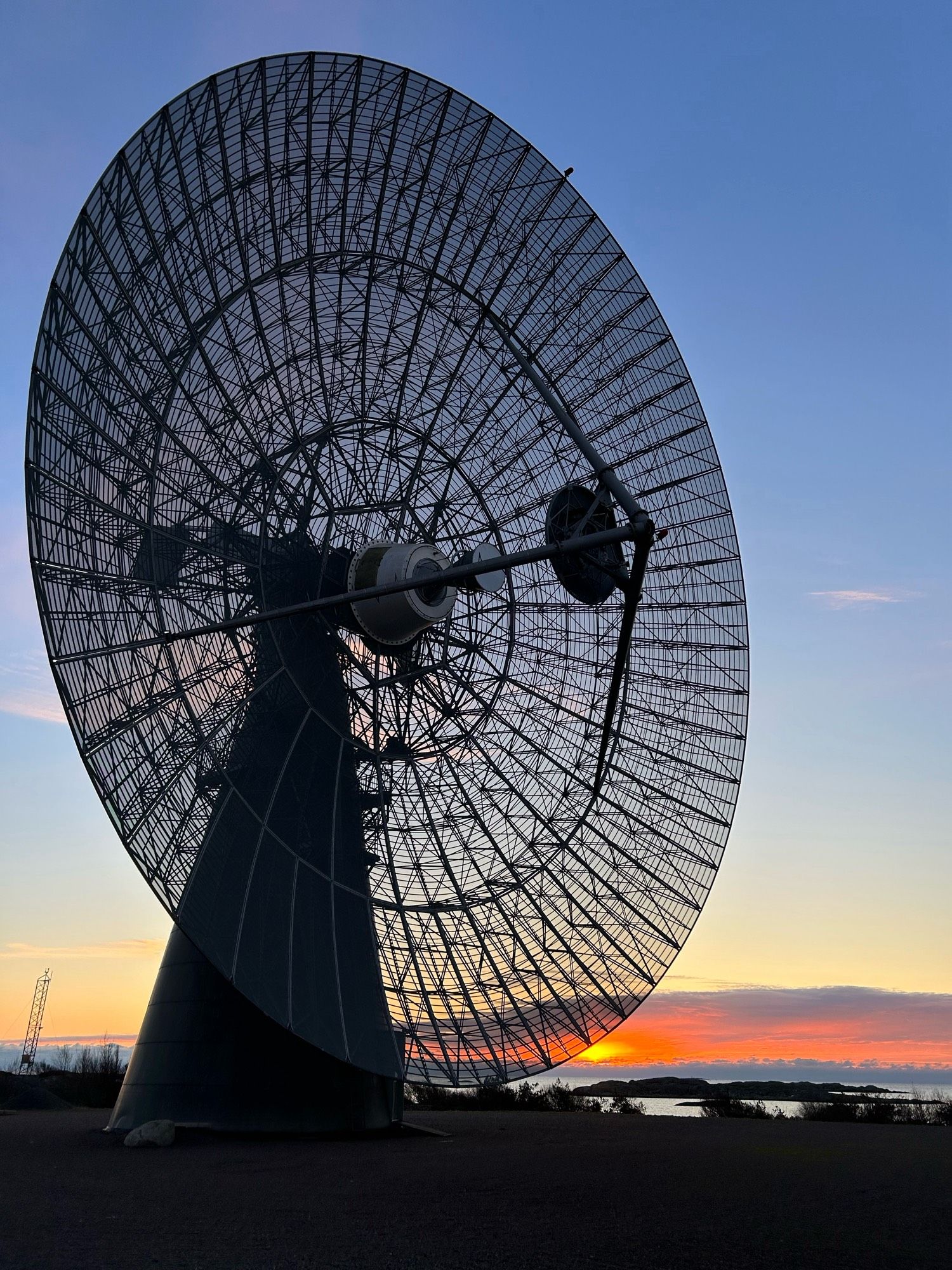 Sunset viewed through the mesh primary dish of the Onsala 25 m.