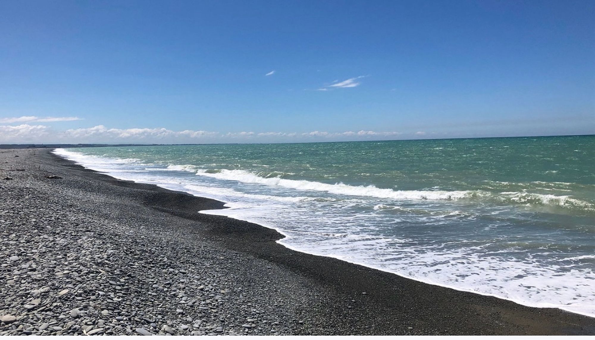 Beach covered with stones and a dangerous sea.