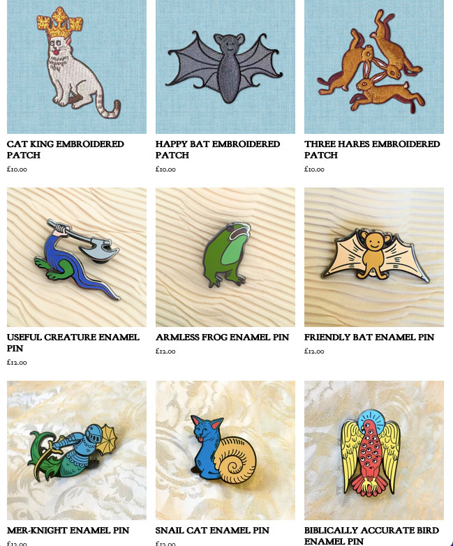 a screenshot of the weird medieval guys bigcartel website showing newly listed enamel pins and patches in a variety of weird medieval designs