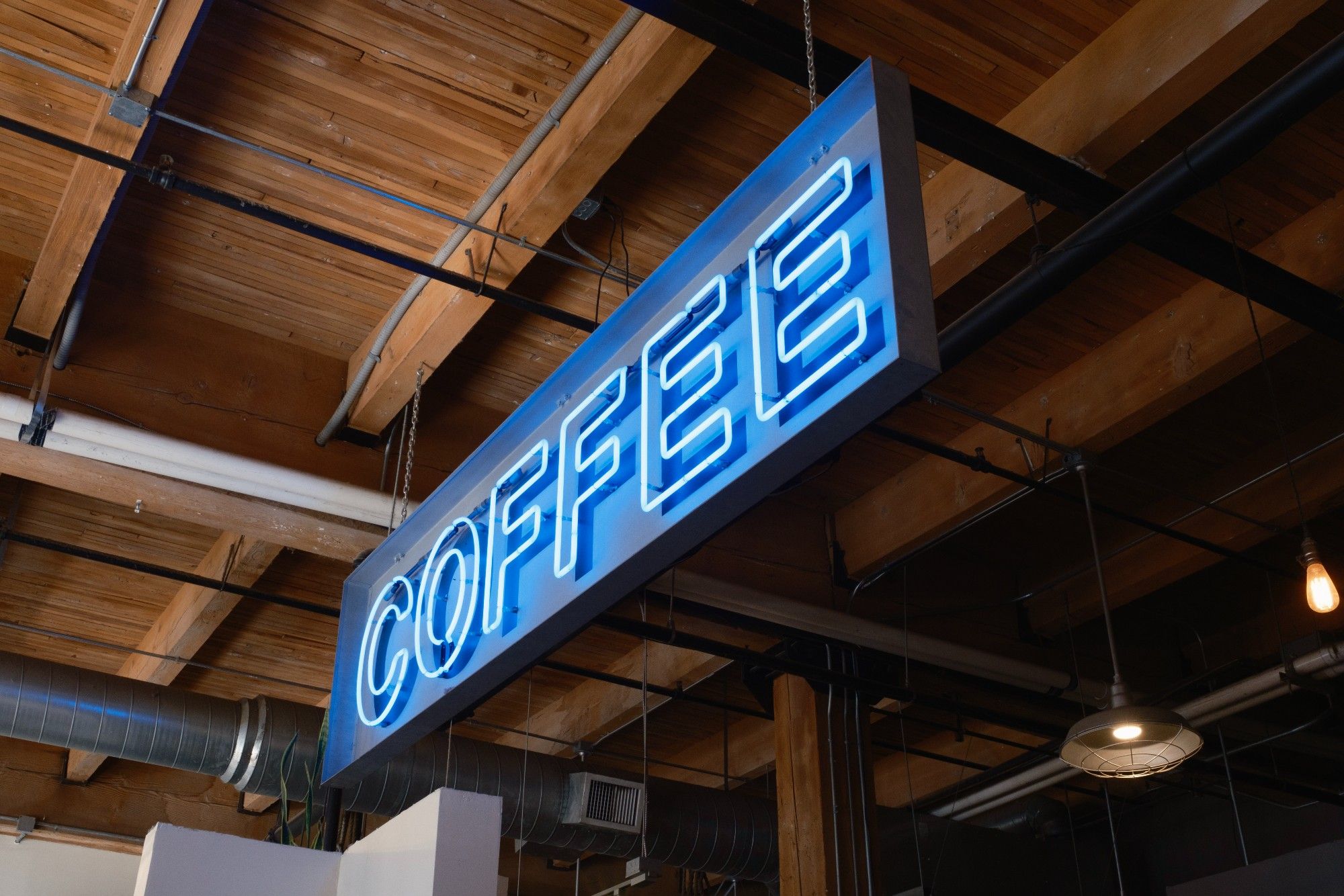 A lit up sign that says COFFEE inside Water Avenue Coffee in SE Portland.