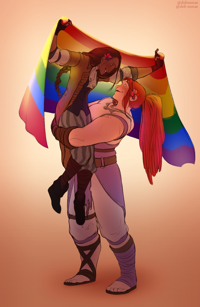 A redhair woman holding another woman in her arms while she holds lgbtq+ flag