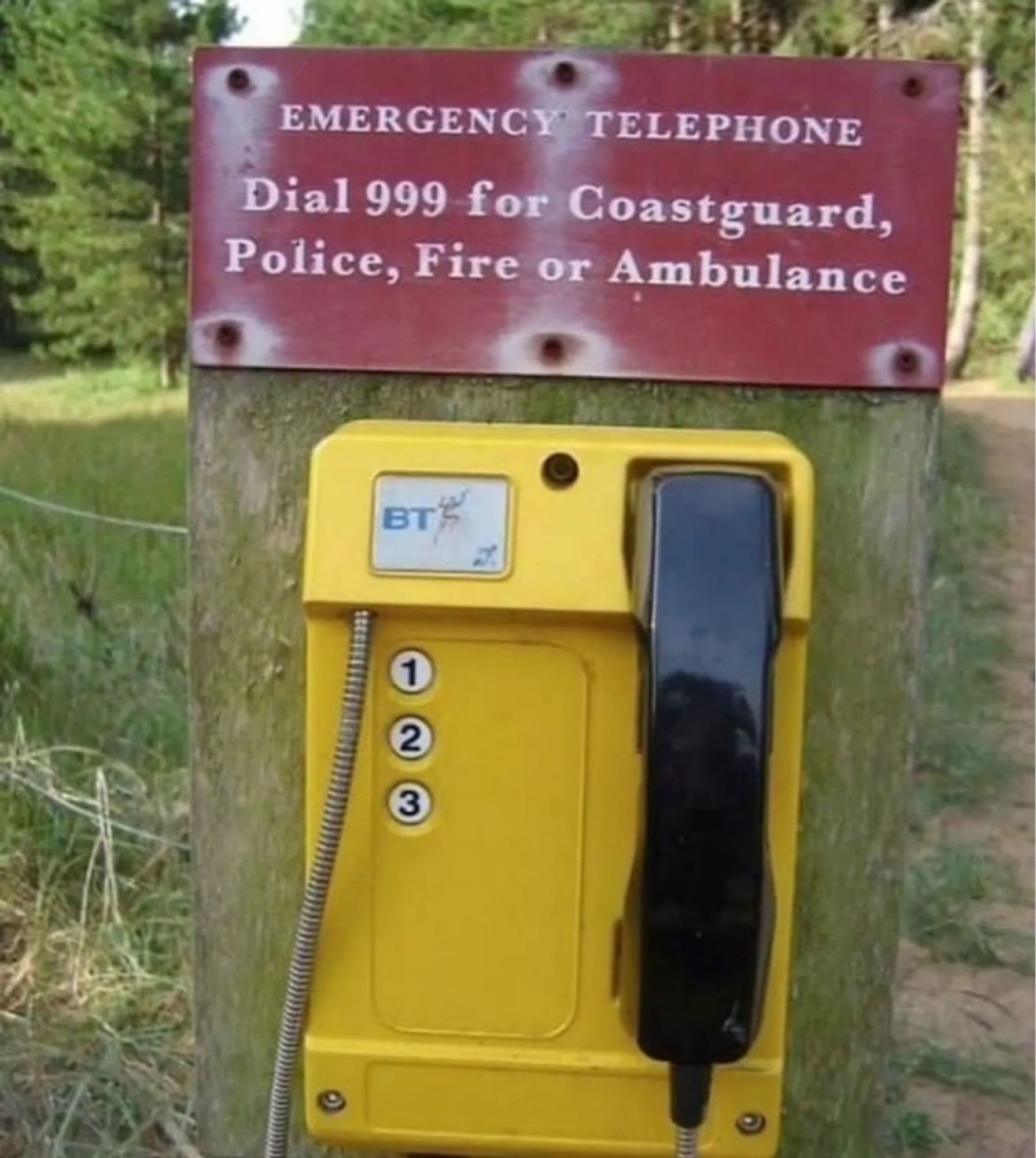 A sign says - emergency telephone dial 999 for coast guard, police, fire, or ambulance
Underneath is a phone with only 3 buttons that say 1, 2, and 3.