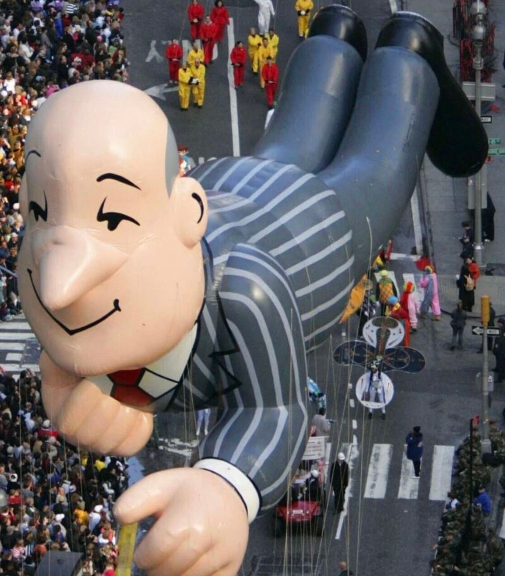 Big balloon shaped like a bald British butler in a pinstripe suit