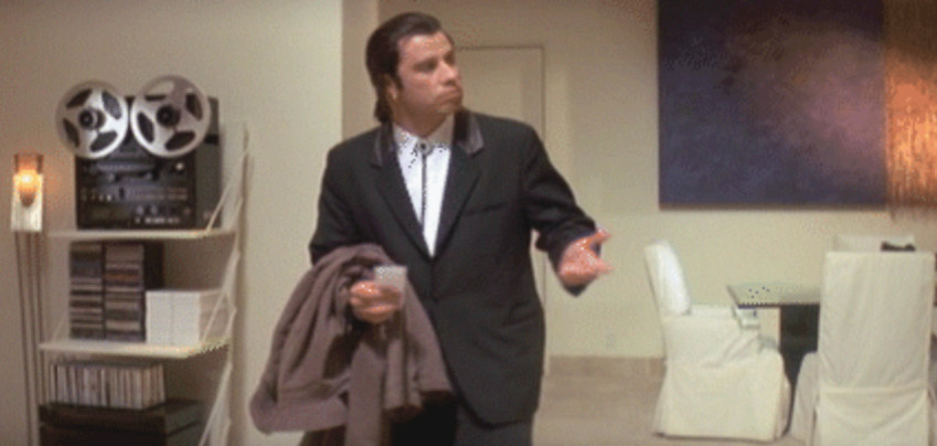 Vincent Vega looking to the right confused with arm raised.