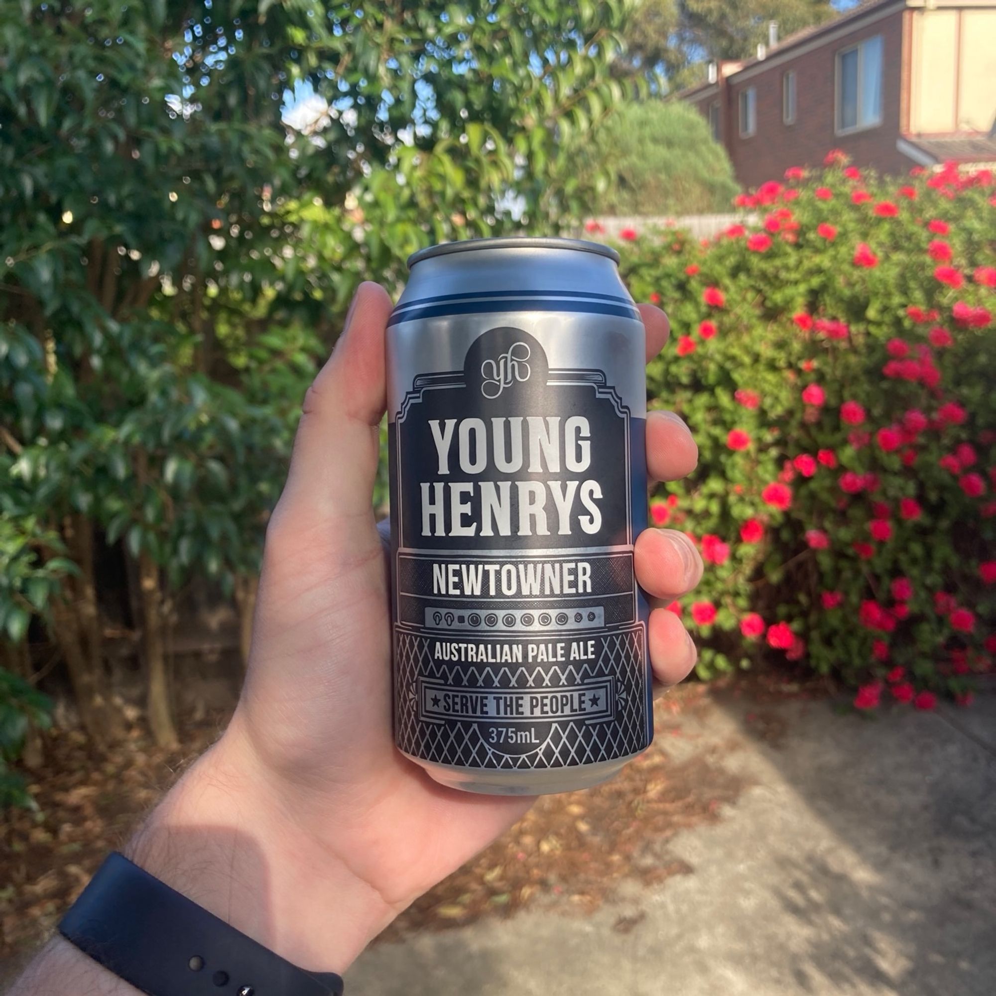 A hand holding a can of Young Henrys Newtowner Australian Pale Ale