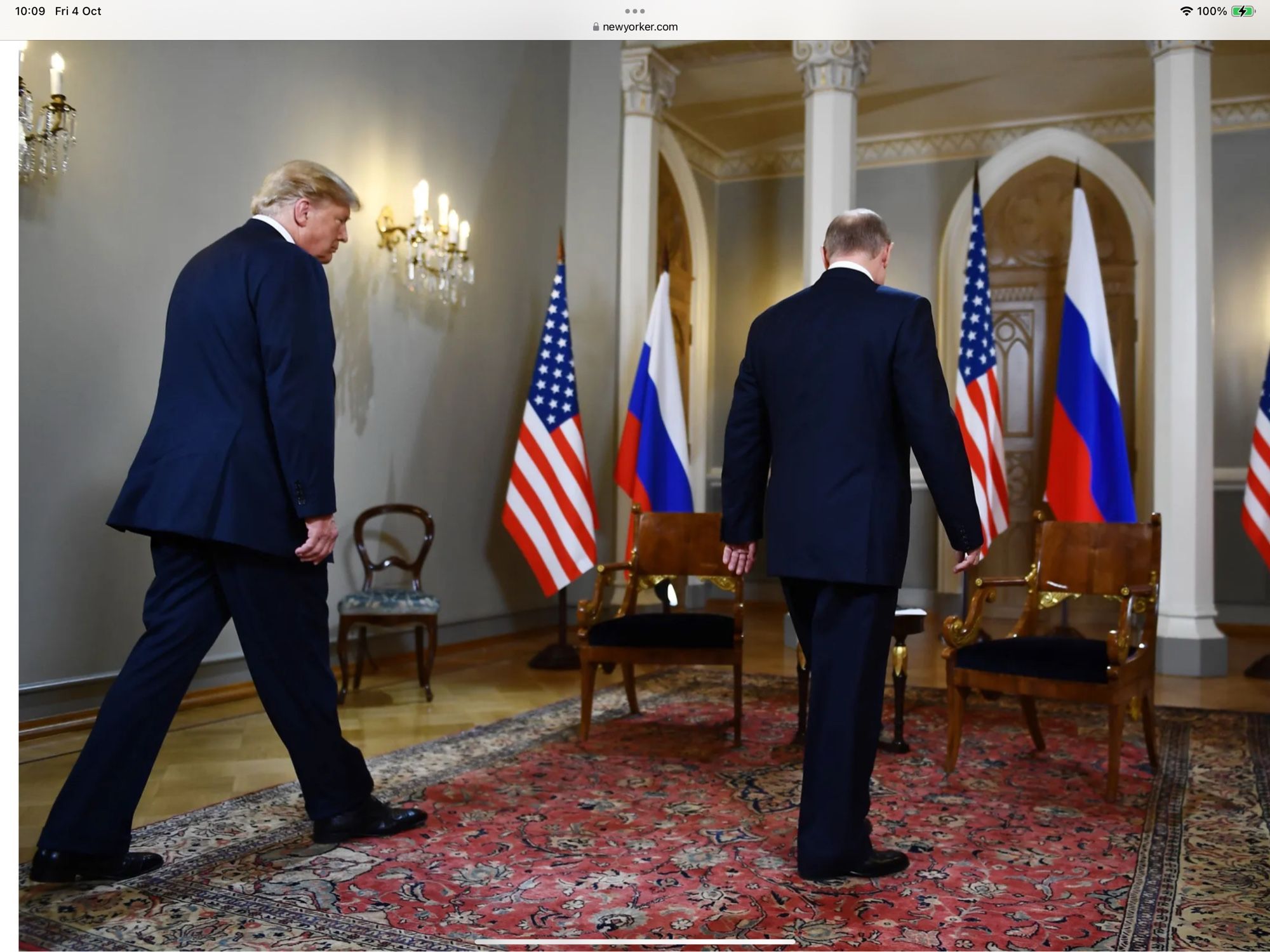 Putin confidently walking towards two chairs for an interview with Trump, who walks behind him with his head hanging