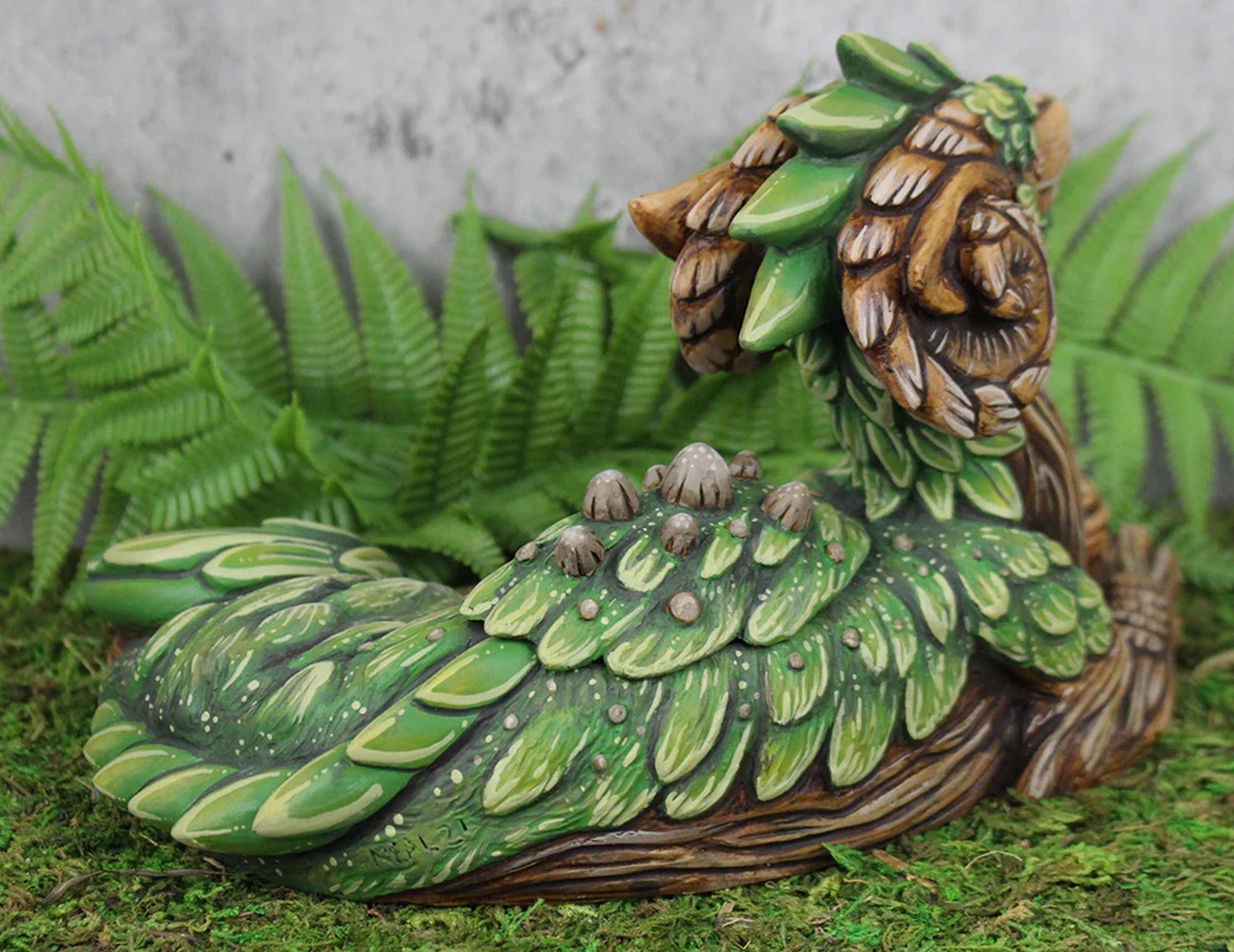 A back view of the mossy tree themed dragon sculpture.