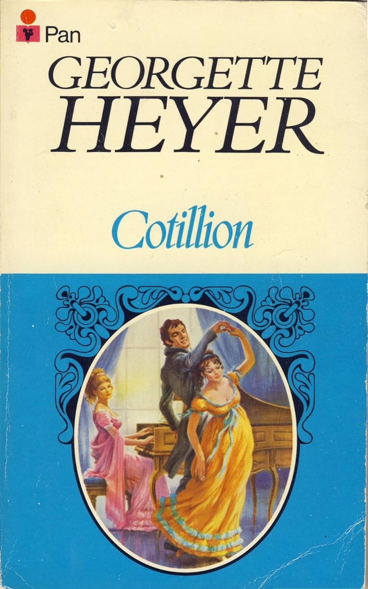 pan books's paperback cover of georgette heyer's cotillion. the background is split into two equal halves of white and blue, upper and lower respectively. in an embellished inset, one brunette person in a yellow regency dress is being twirled by a person in a regency tailcoat while a blonde person in a pink regency dress is playing the pianoforte and looking on.