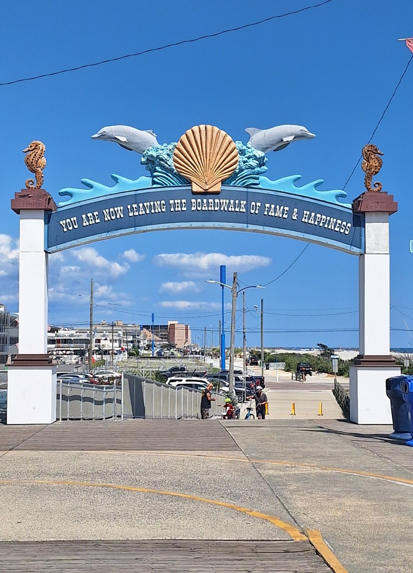 The gate at the northernmost end of the Wildwood boardwalk, the text on which reads You Are Now Leaving The Boardwalk Of Fame And Happiness.