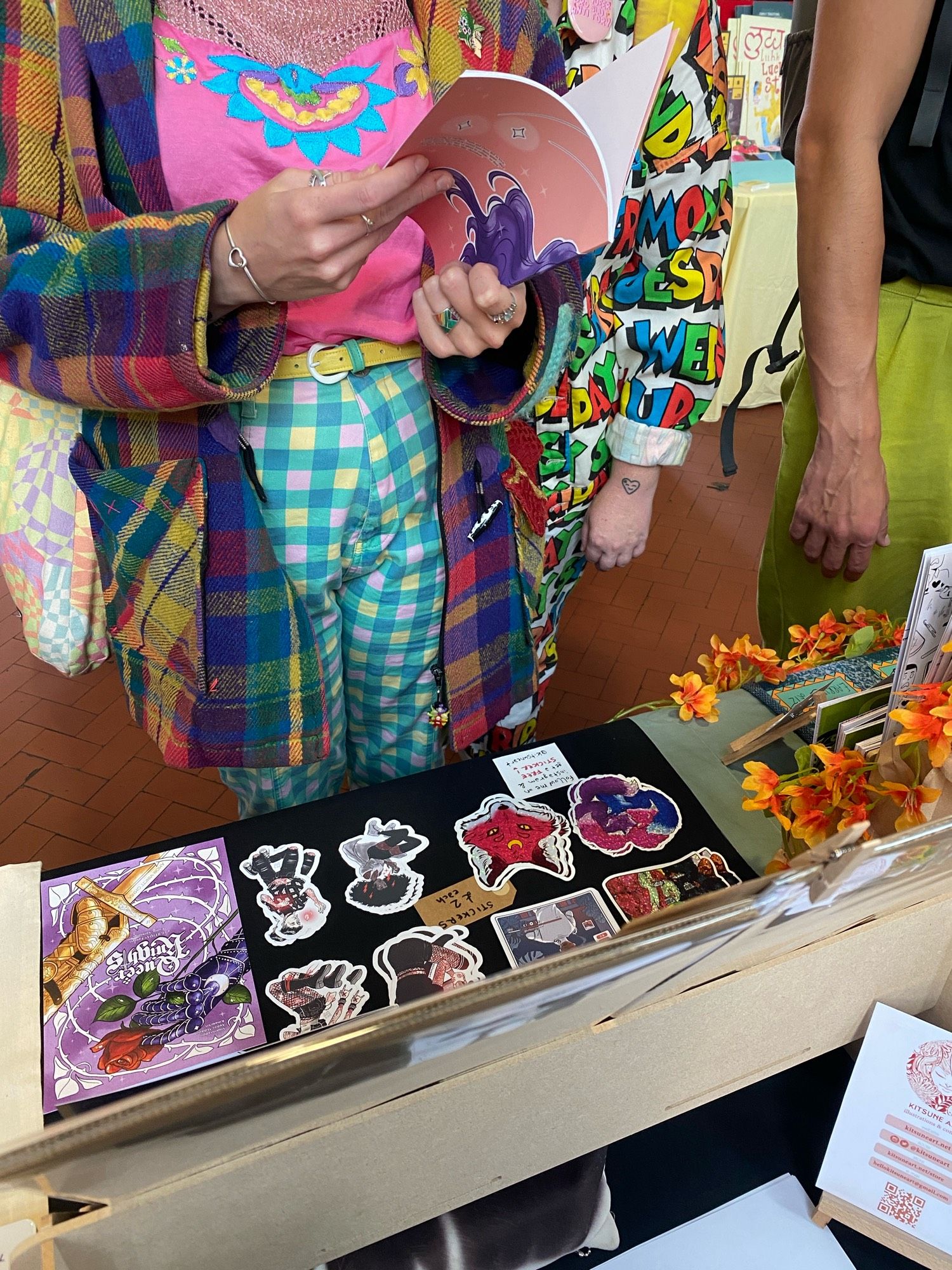 Close up on an attendee checking starlit lovers comic