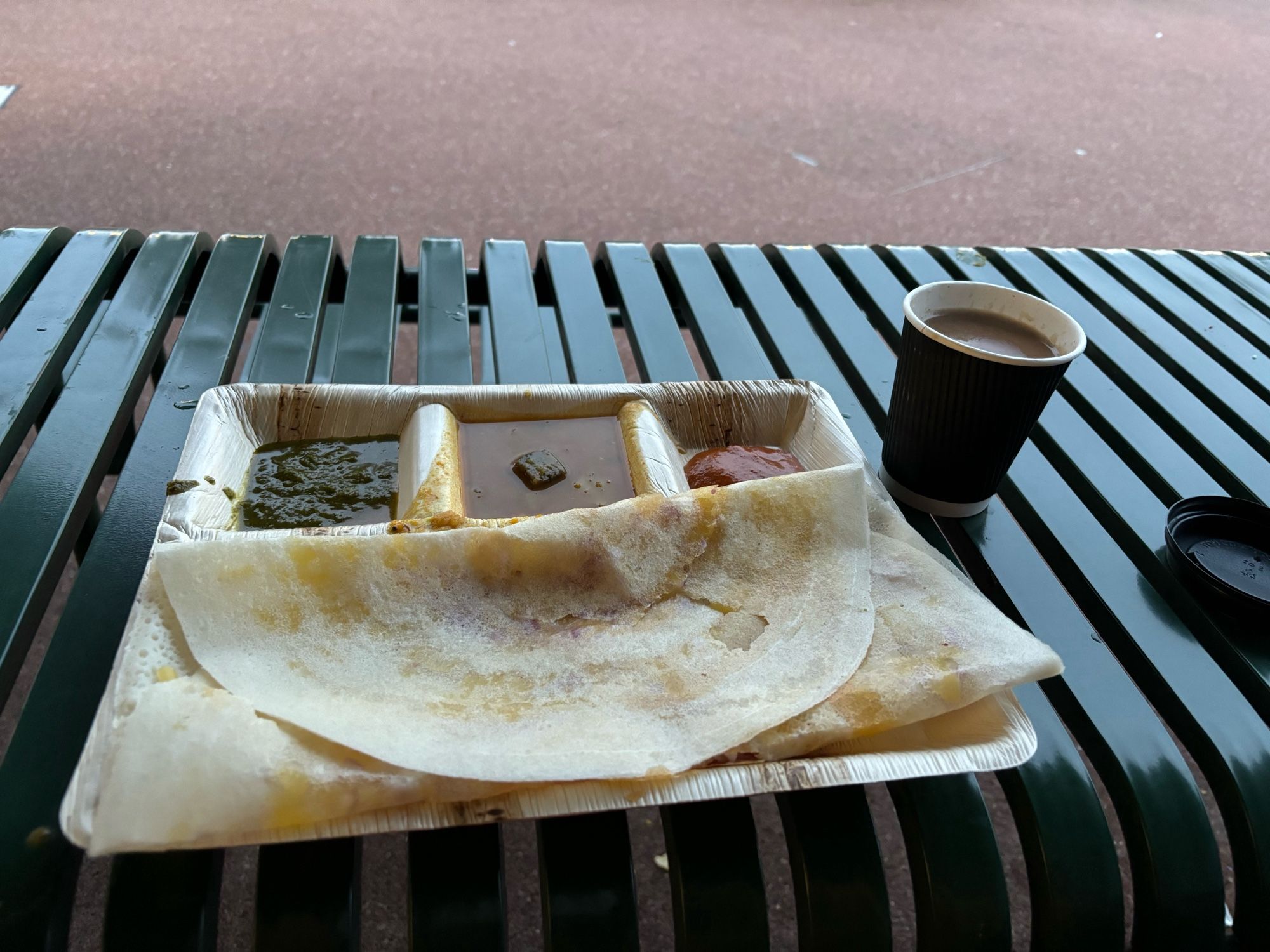 Cheese and onion dosa with chutneys, curry and a masala chai