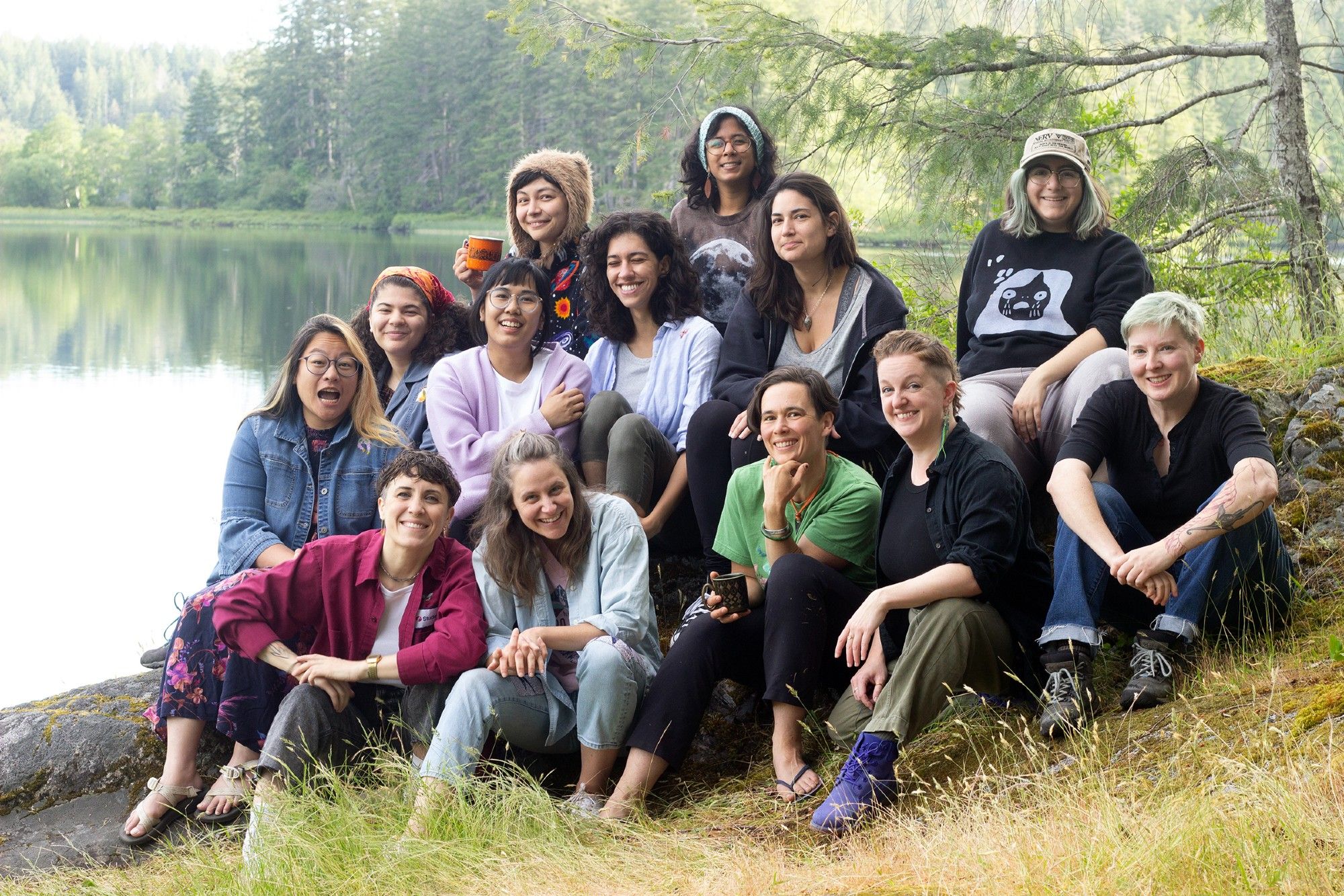 A group of artists gathered beside a lake