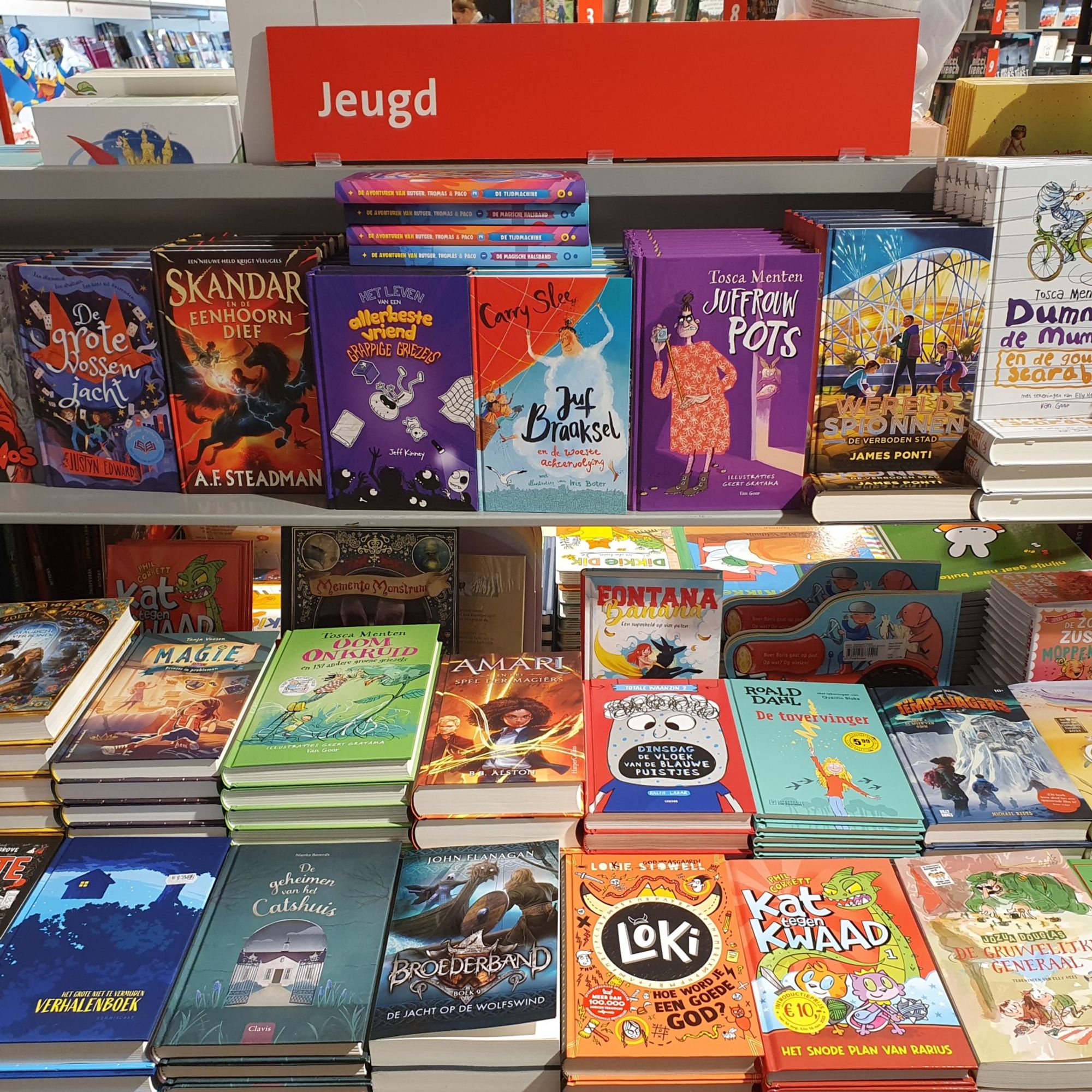 "Jeugd" tiered book display with various Dutch children's books in translation at my local Bruna stationary shop in Voorburg, Netherlands.