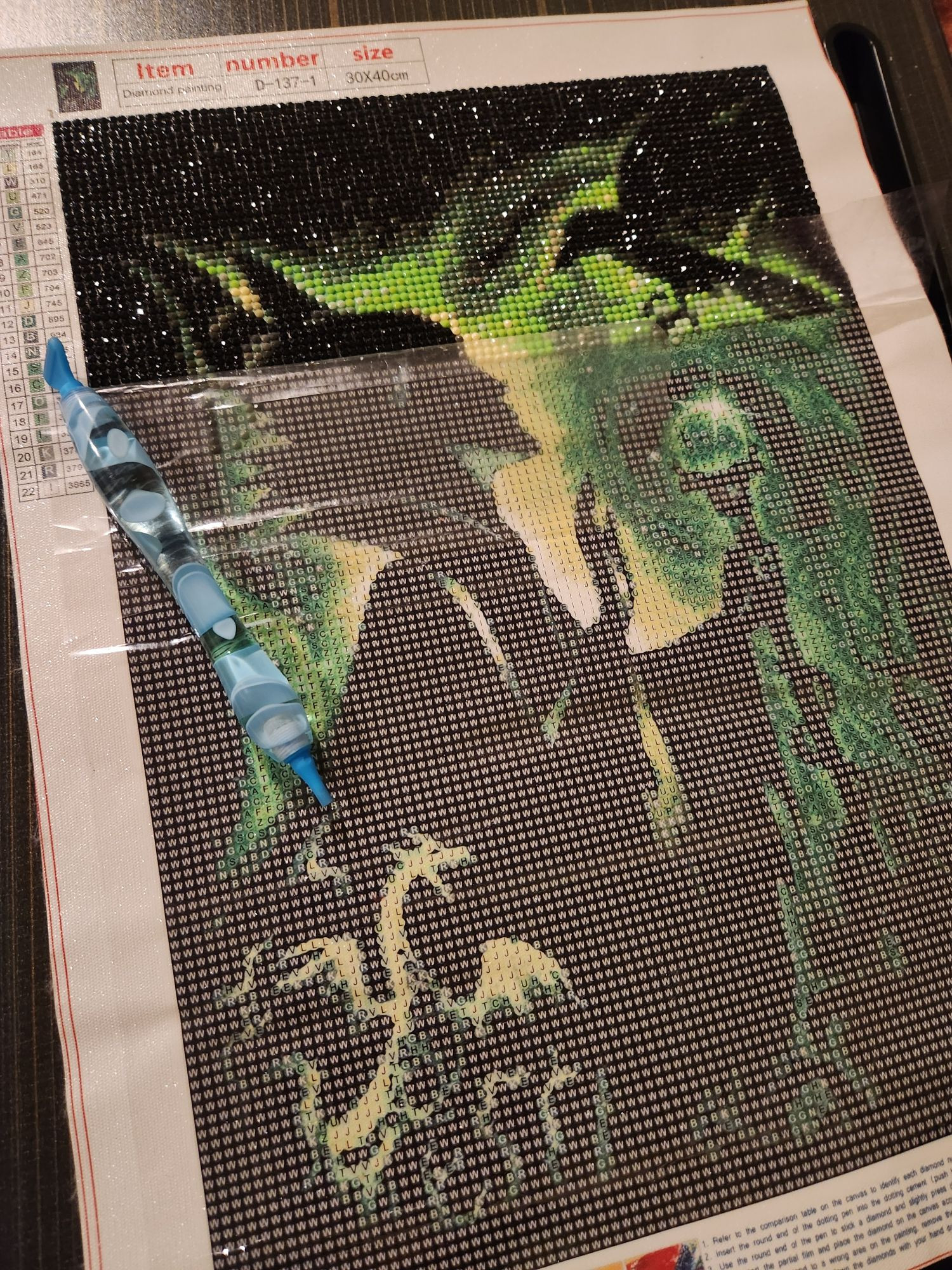 An image of the Disney Villain, Maleficent, with partial rhinestones on the top portion of the image, about 25% completed.