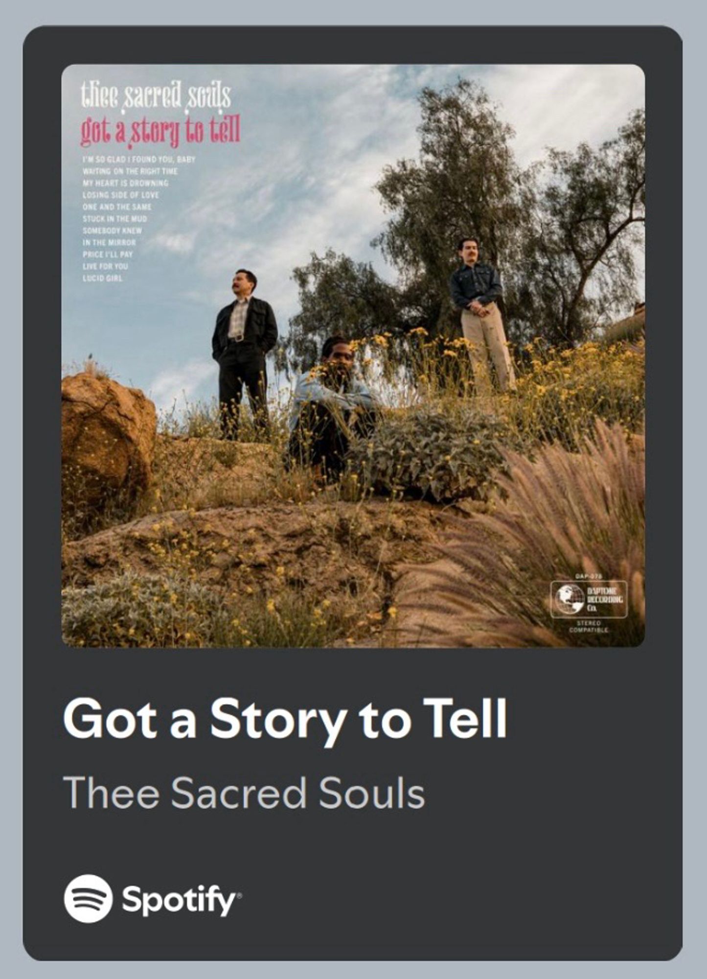 Got a Story to Tell by Thee Sacred Souls. Shows 3 men standing in a desert setting. The album name and track listing is superimposed over the photo.