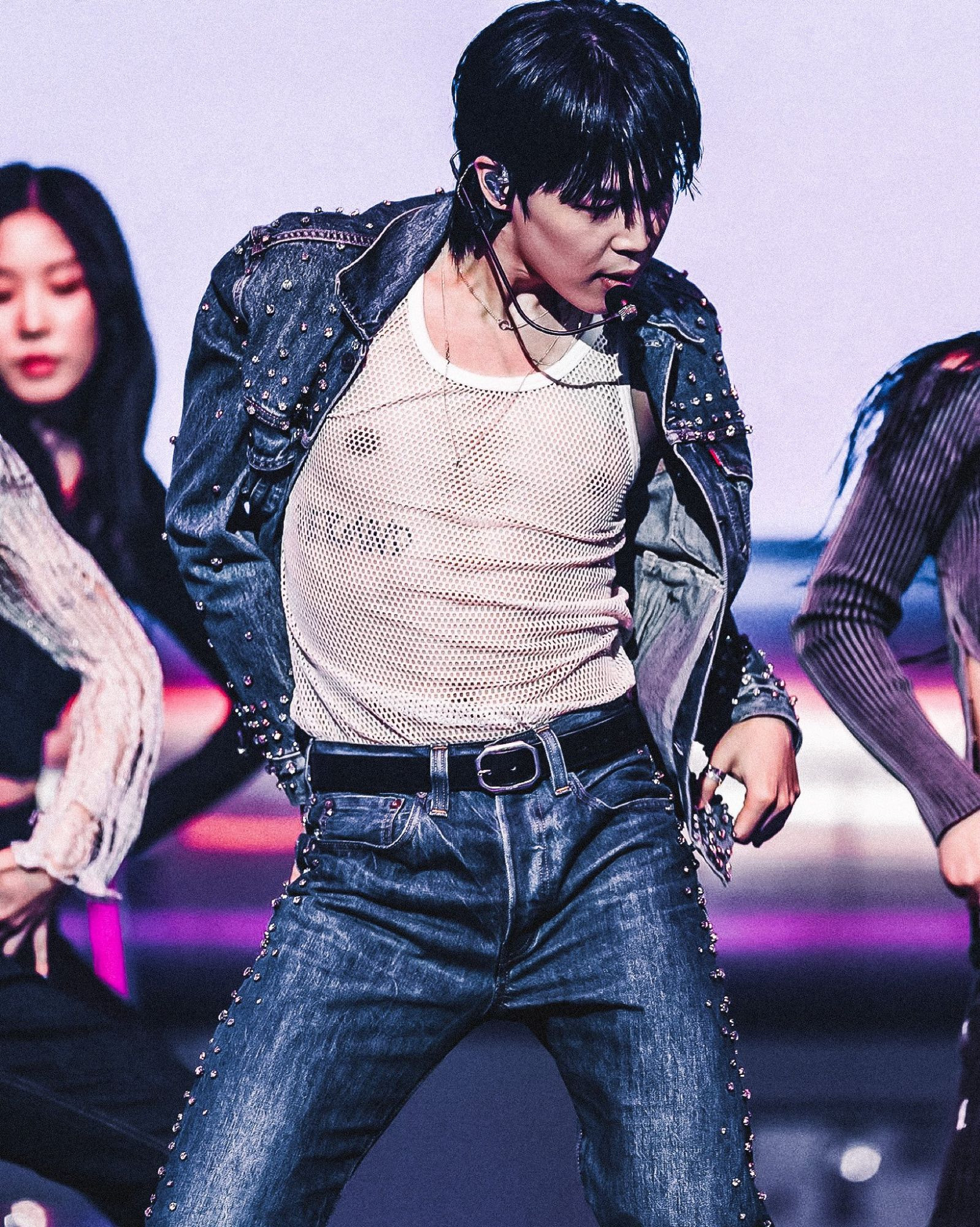 Jimin of BTS on stage in a bejewelled jeans outfit over a white mesh shirt