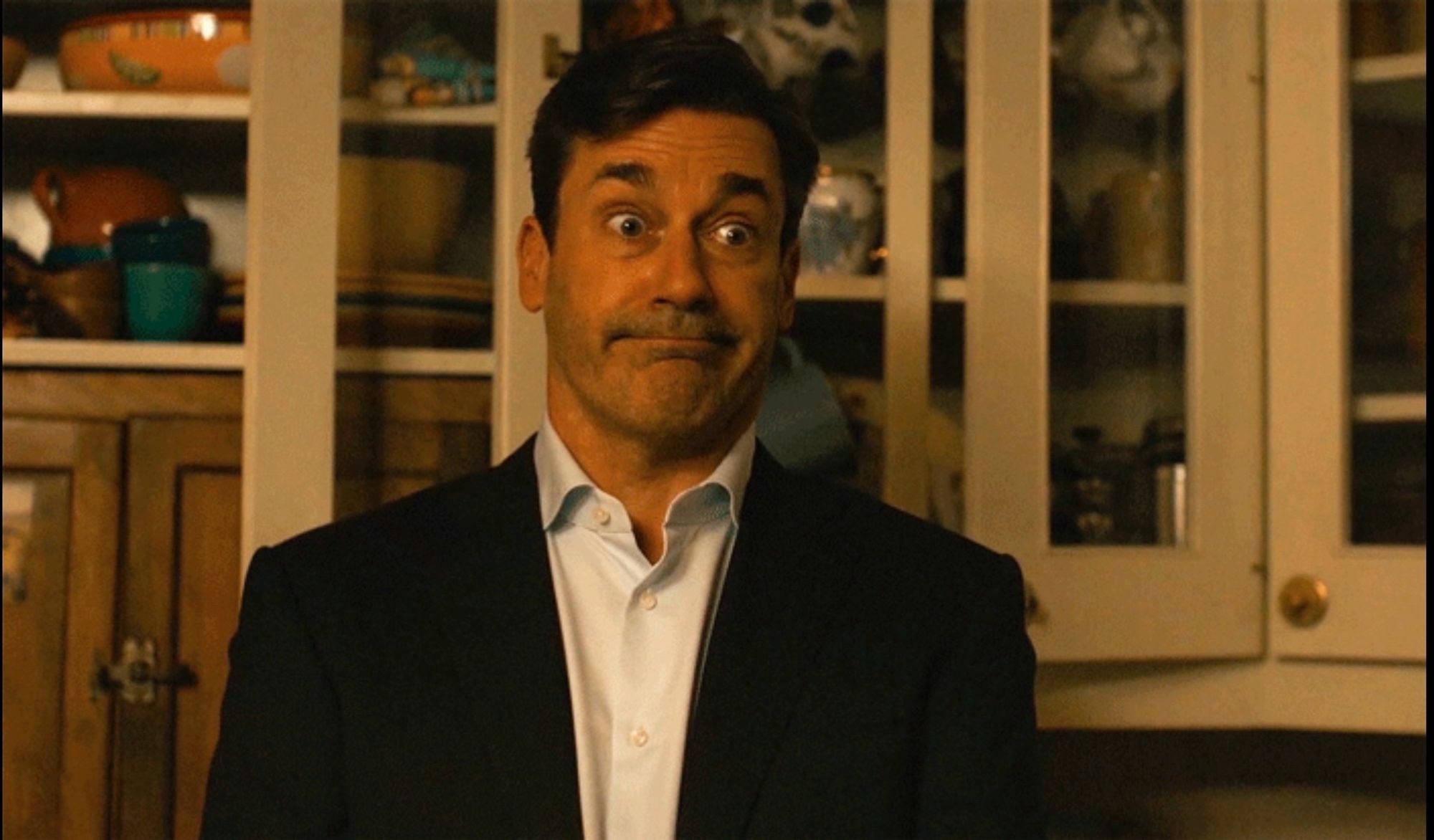 Jon Hamm as Fletch, wide eyed and grimacing, from “Confess, Fletch”