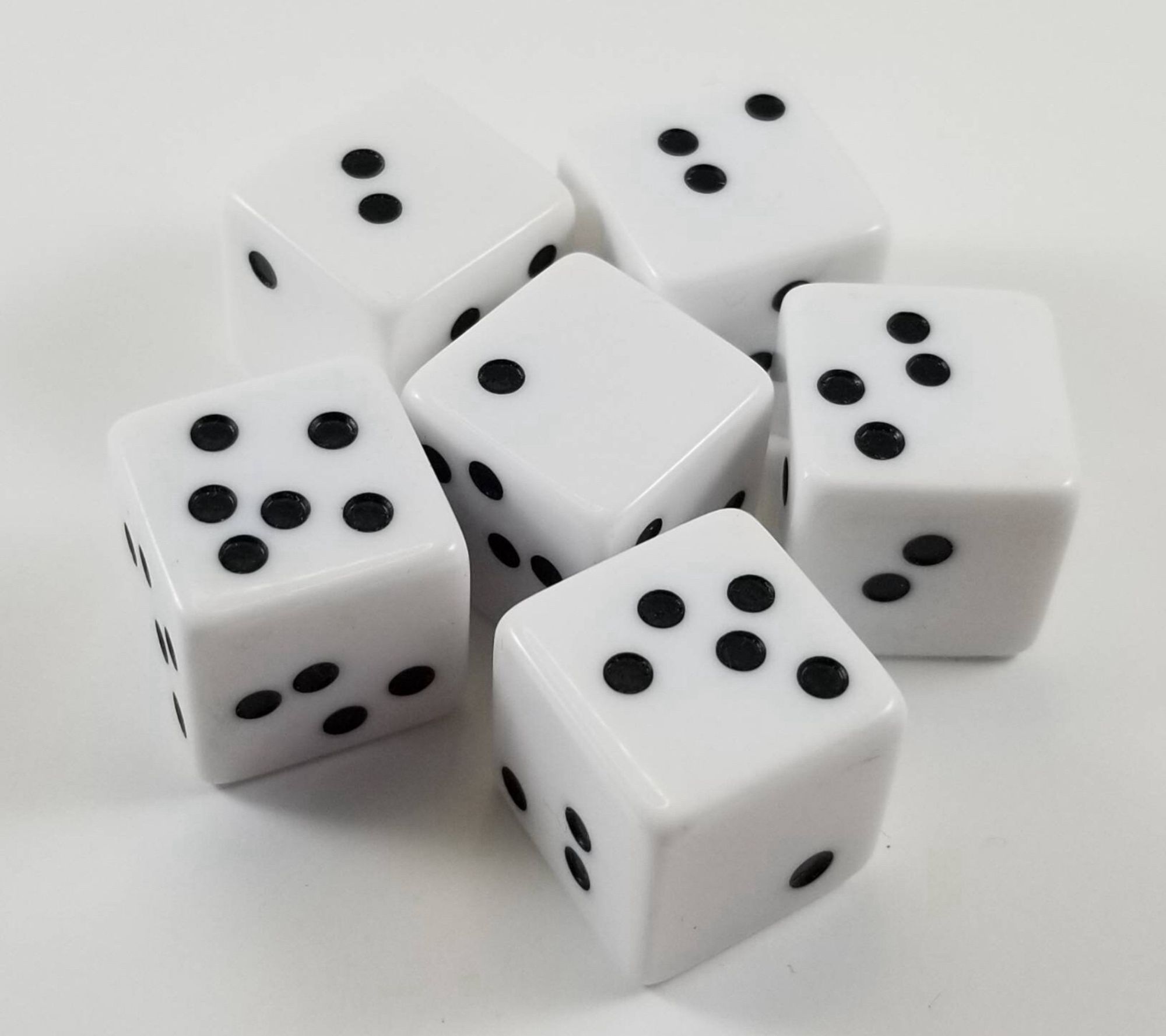 A set of 66 sided dice, white with black pips, except the pips are locked, where they normally are and seem as if the dice were somehow shaken, and the pips got scrambled around