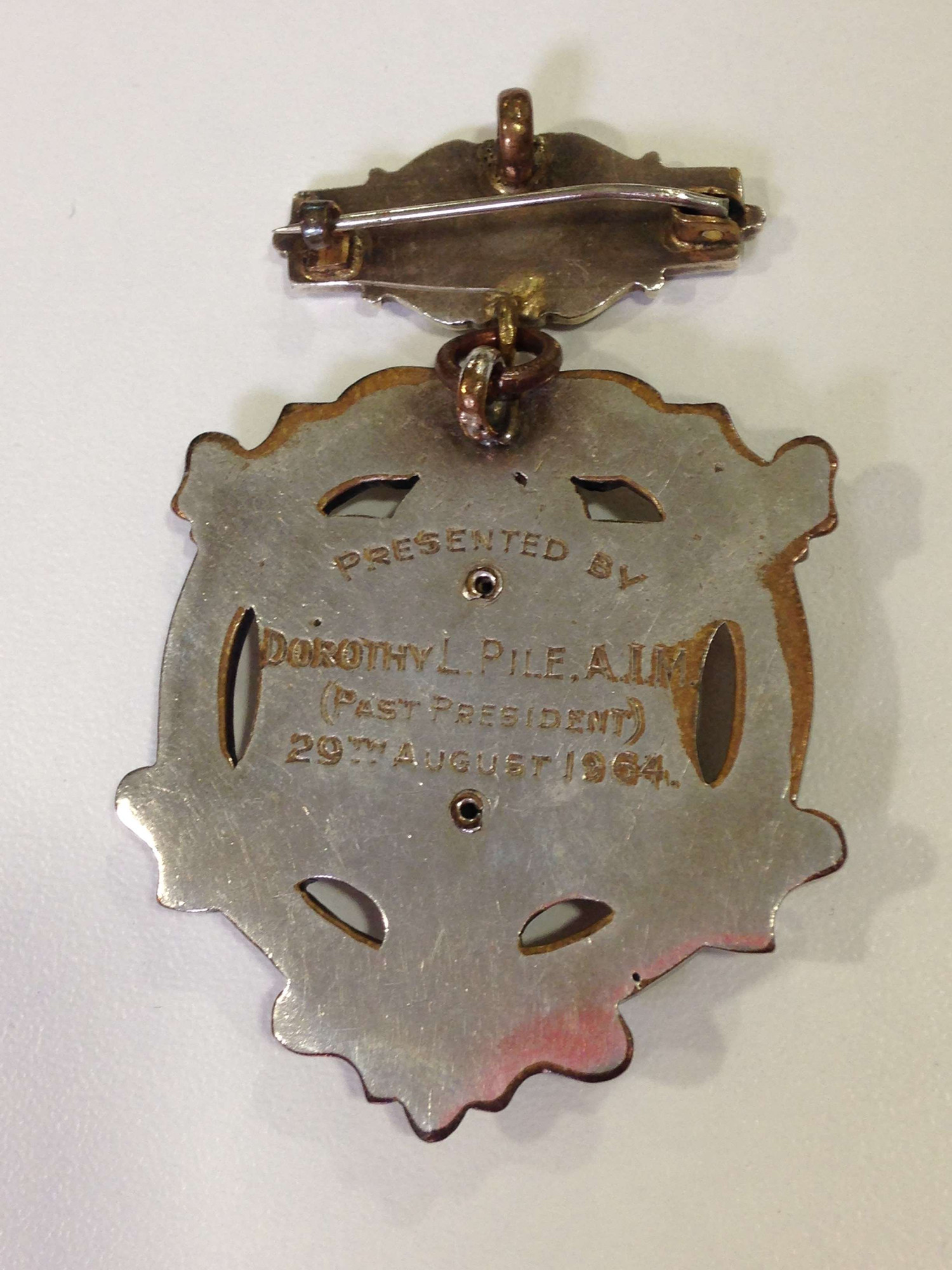 Back of Women's Engineering Society President's badge engraved with "Presented by Dorothy Pile (Past President) 29th August 1964"