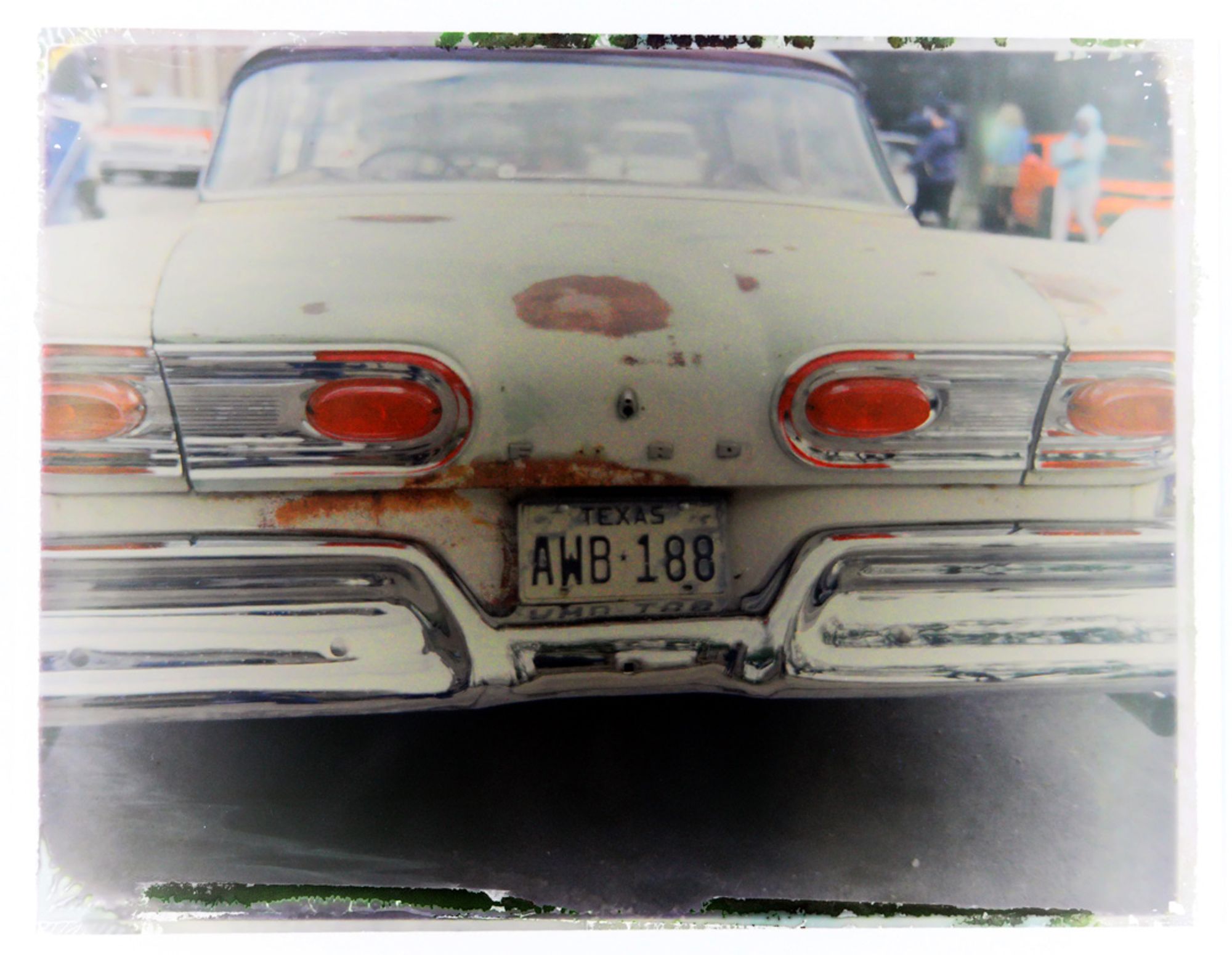 A color photo of the rear-end a 1958 Ford Fairlane made from the reclaimed negative of a Fujifilm FP100c peel-apart print.