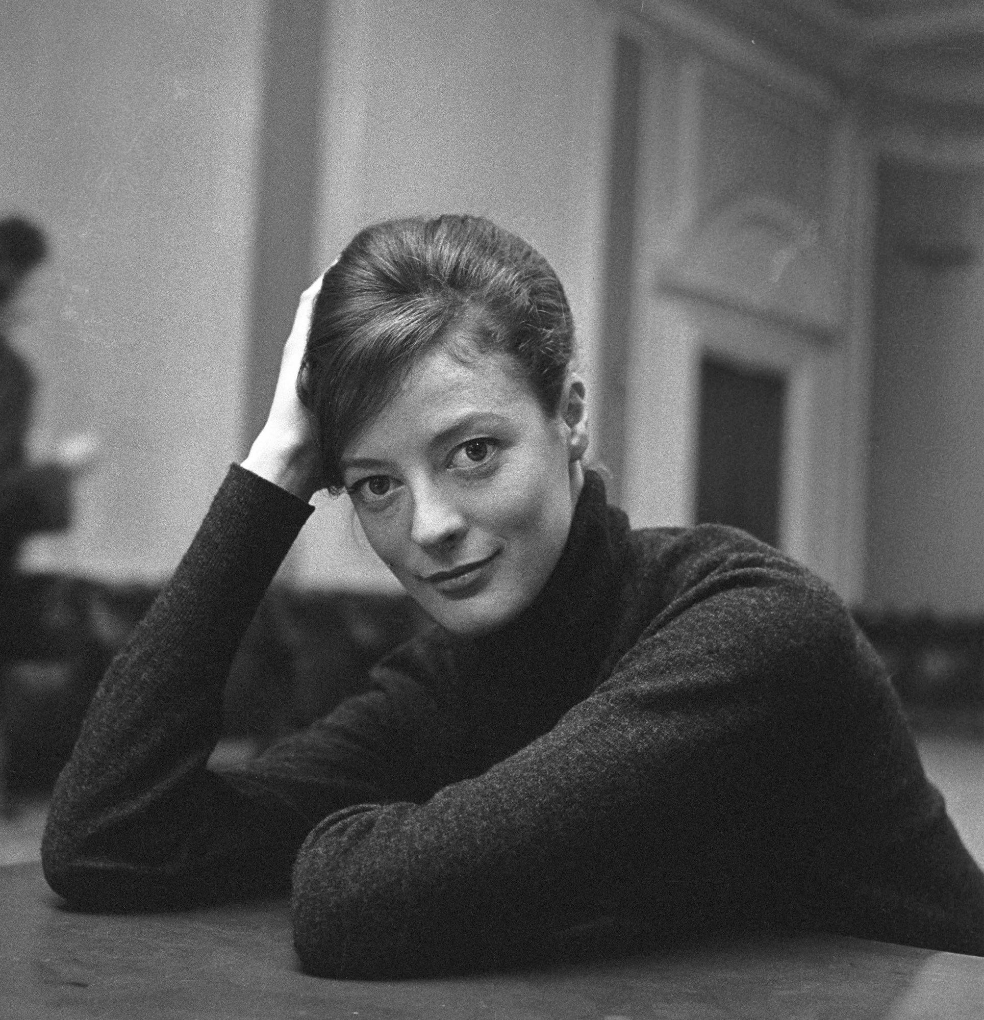 Black and white image of a beautiful young Maggie Smith, looking frankly into the camera.