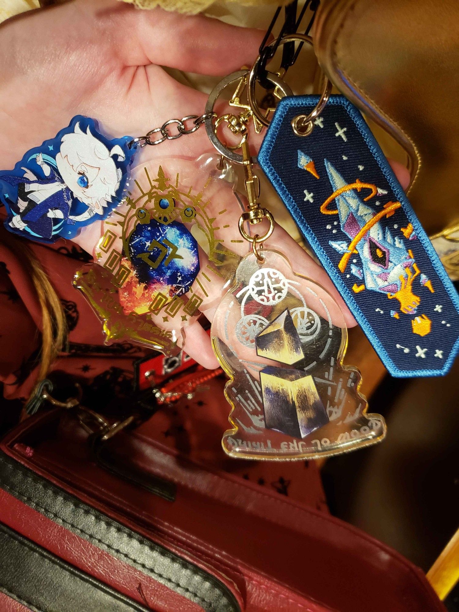 A photo of a handful of blue ffxiv keychains.