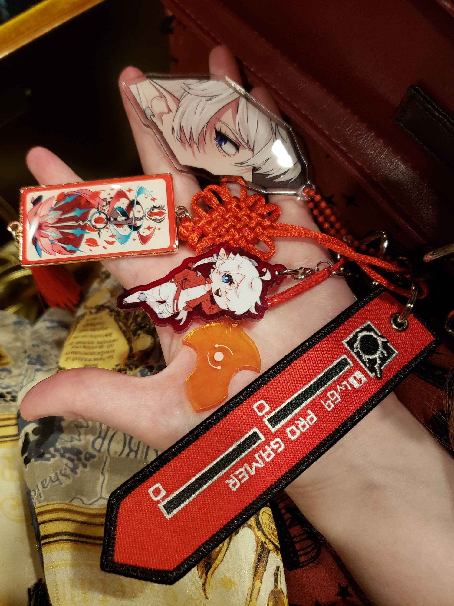 A photo of a handful of red ffxiv keychains.