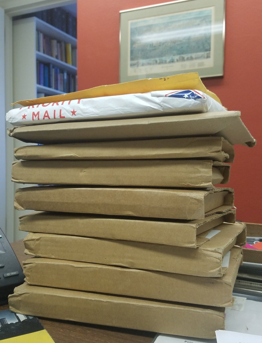 Stack of book packages going out in the mail for review