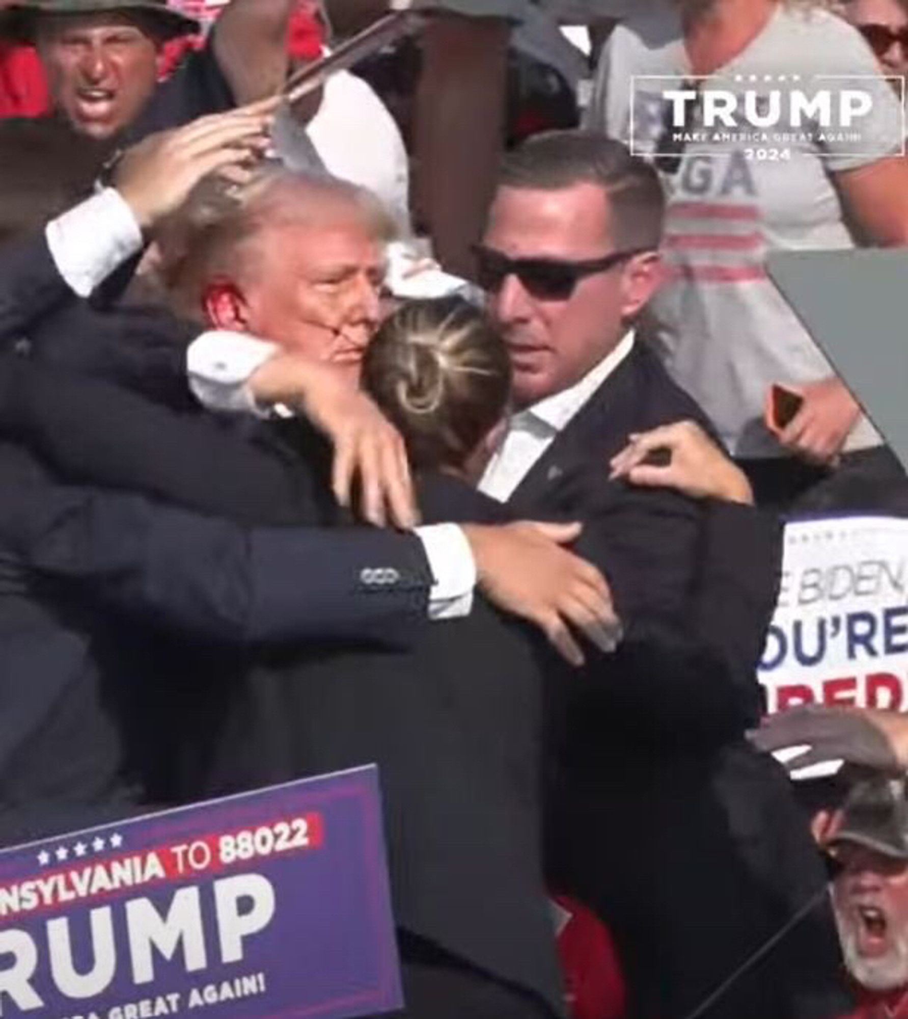 Another photo of the rally and trump right after he’s shot with the secret service agents covering him