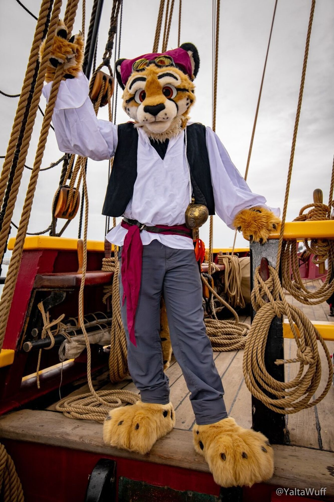 Photo of Obscura dressed in a pirate costume standing on the deck of a sailing ship