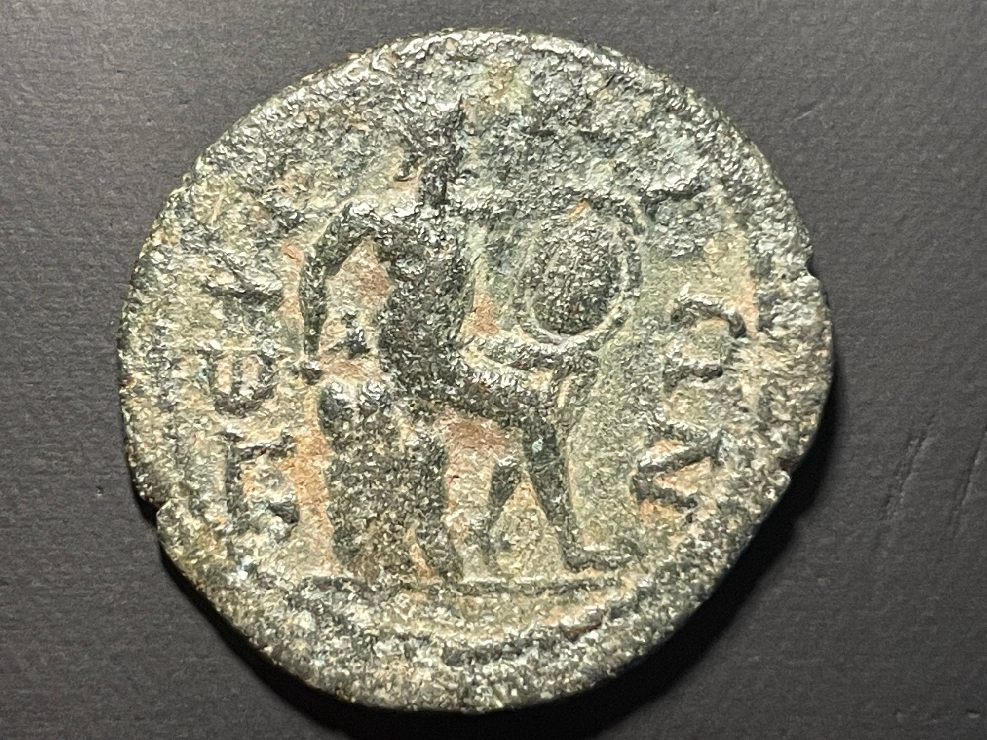 Reverse ΠEPΓAIΩN
Hephaestus seated on rock right, holding hammer and shield placed on knee