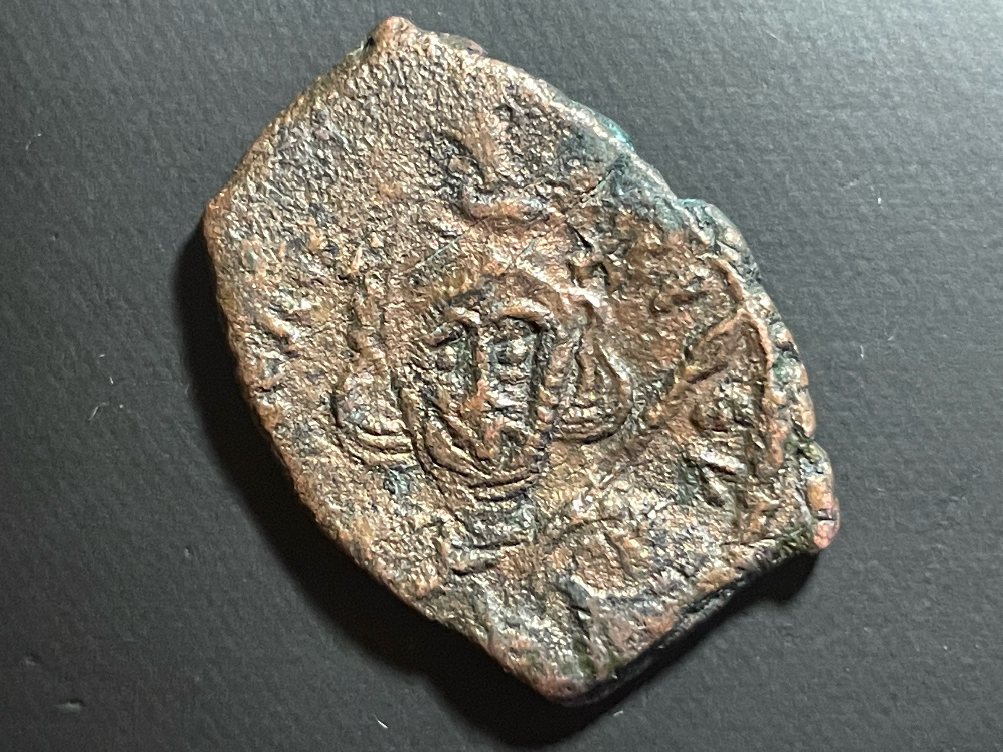 Obverse D TIBERIUS PE V
Bust of Tiberius III front, wearing crown and cuirass, holding spear and shield