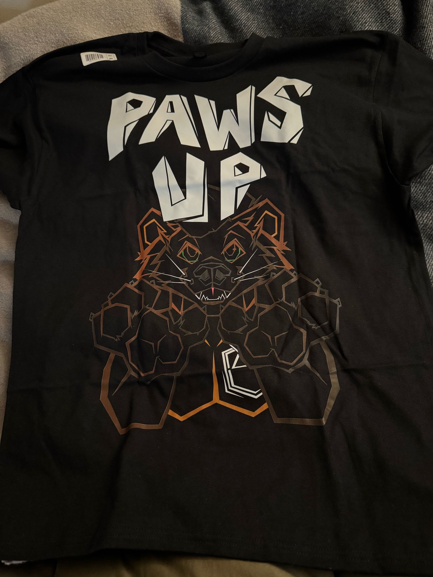 Black t shirt with the caption Paws Up and a fisher holding up his paws