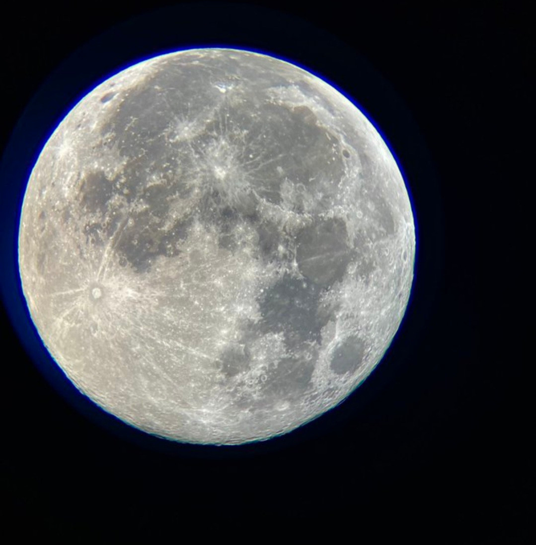 Photo of a full moon with various "markings" across its surface