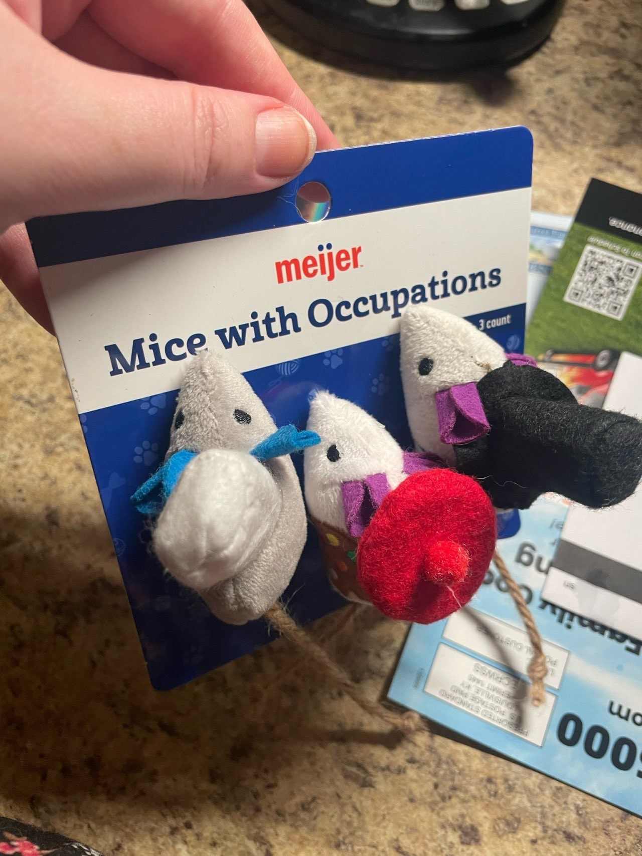 Cat toy called "mice with jobs". Three small felt white mice, one in a puffy white hat, one in a flat round red hat, and one in a tall black top hat