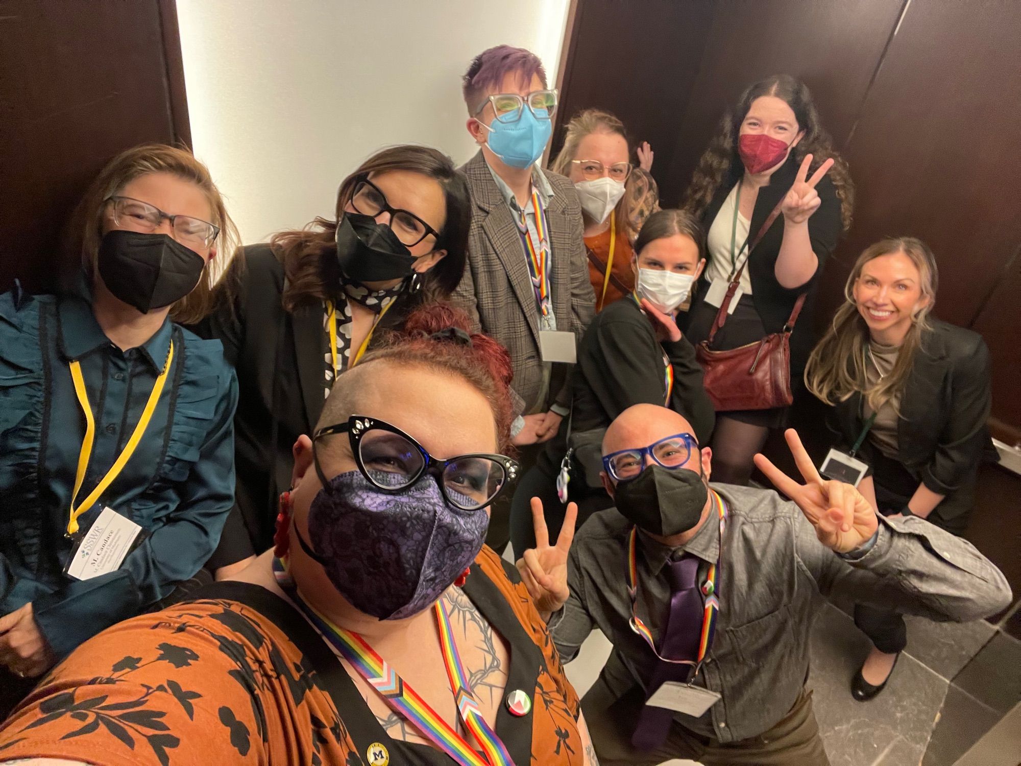 Group of masked folks posing in an elevator