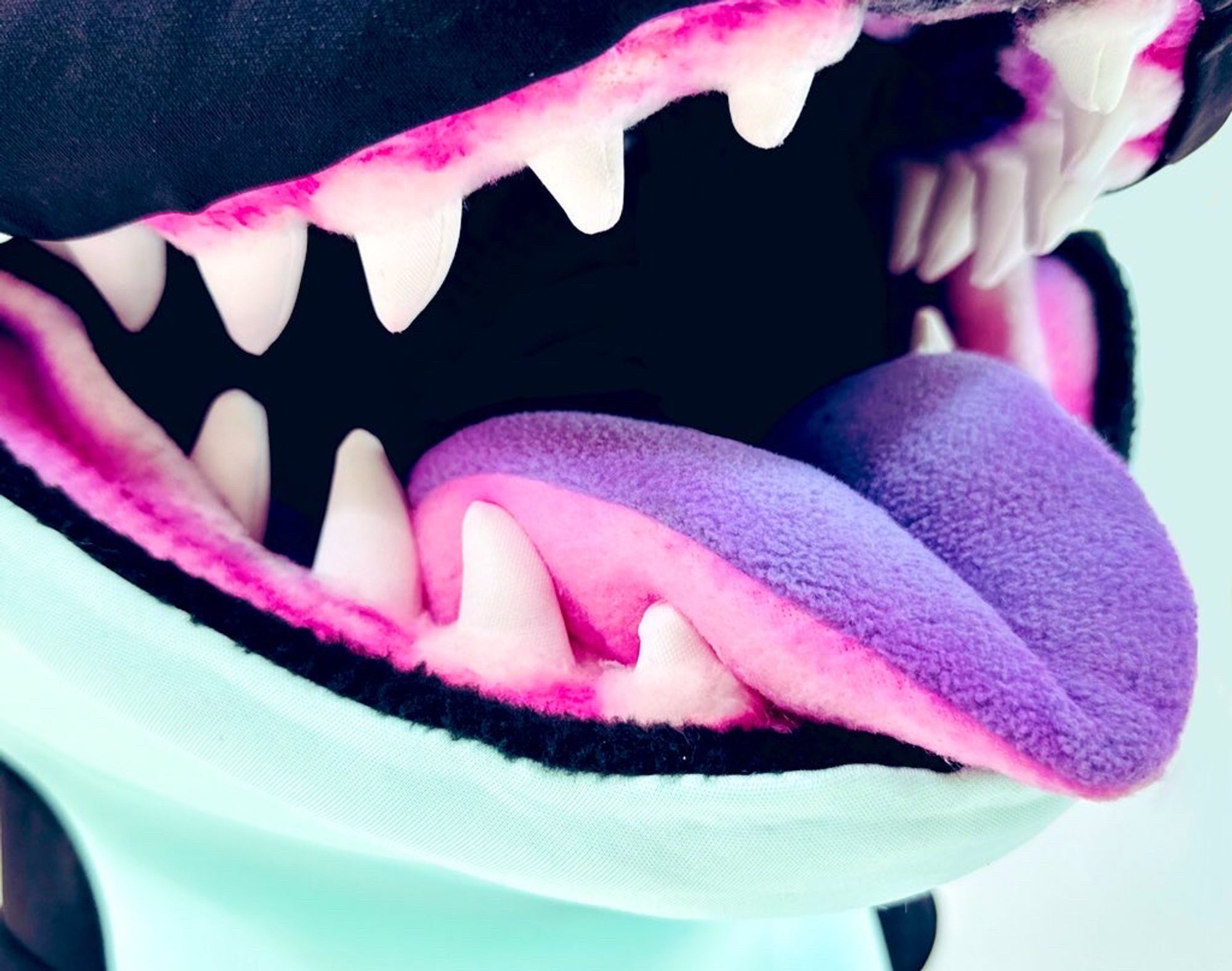 The pillowy tongue of an orca Fursuit.