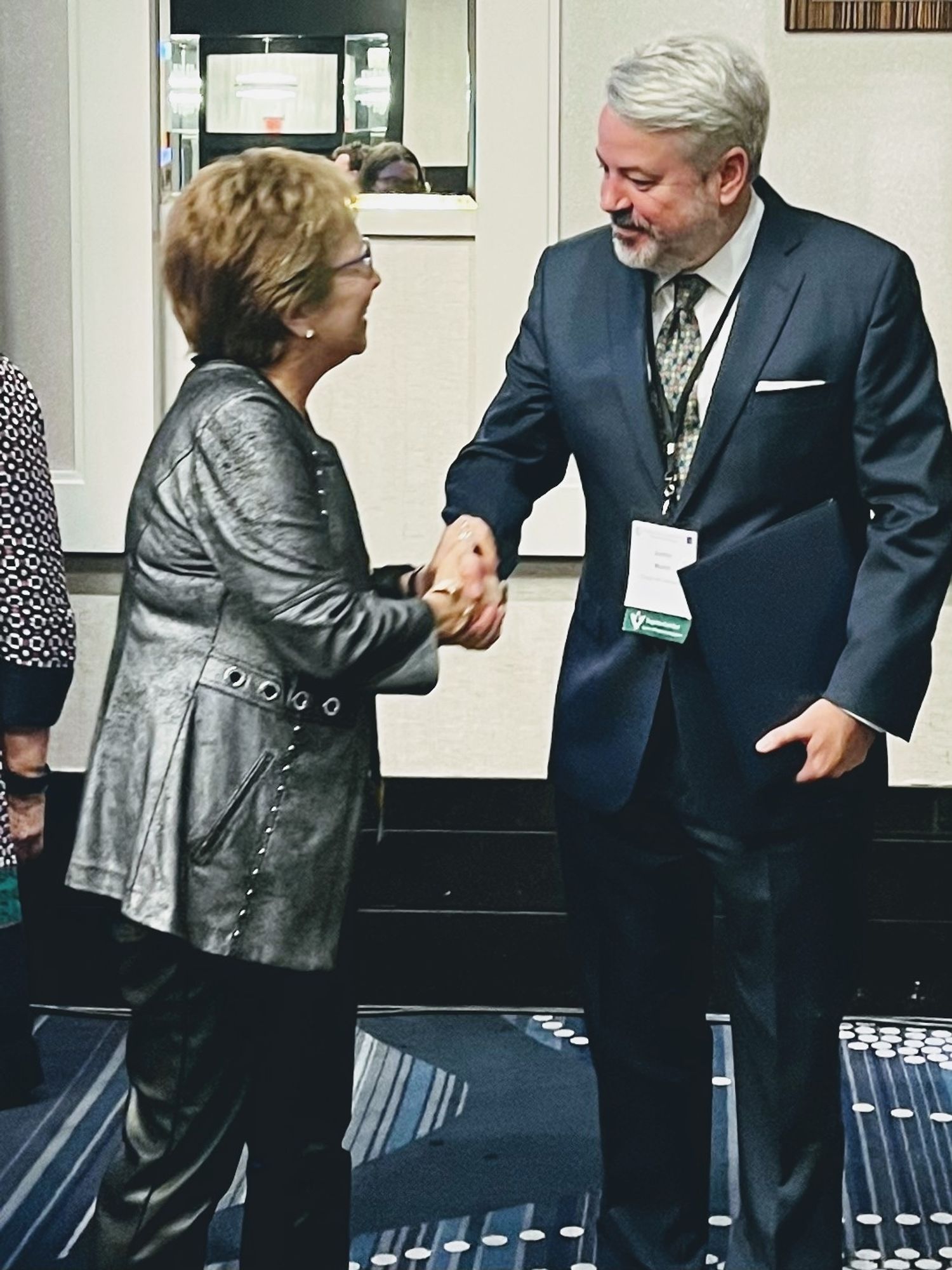 The author shaking hands with AIA president Laetitia LaFollette