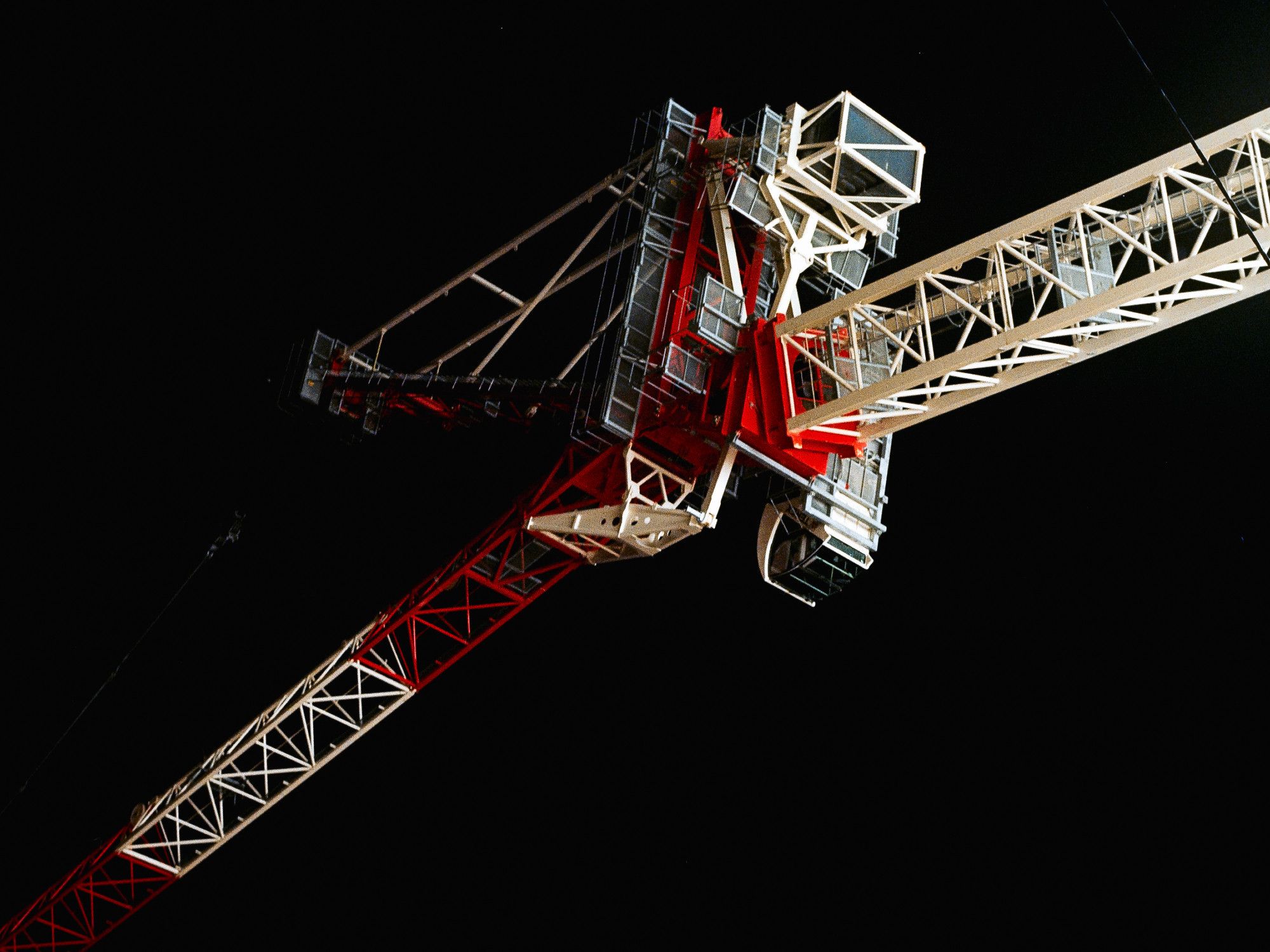 a picture of red and white machinery in front of a black background with some faint stars, it is reminiscent of pictures of machines in space