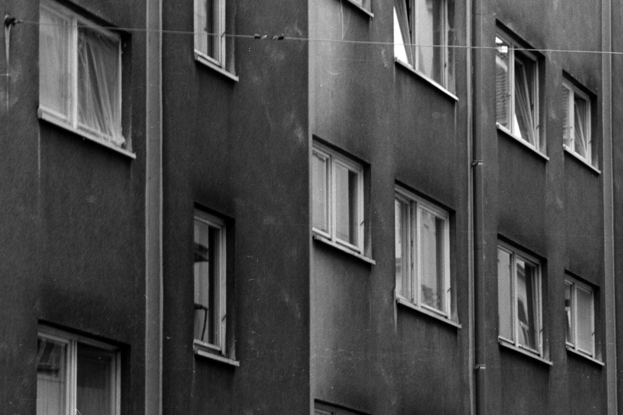 a black and white picture of windows in vienna. it is framed to enhance the geometry and perspective, with two strong directions of lines crossing, vertical and top-left to bottom-right diagonals